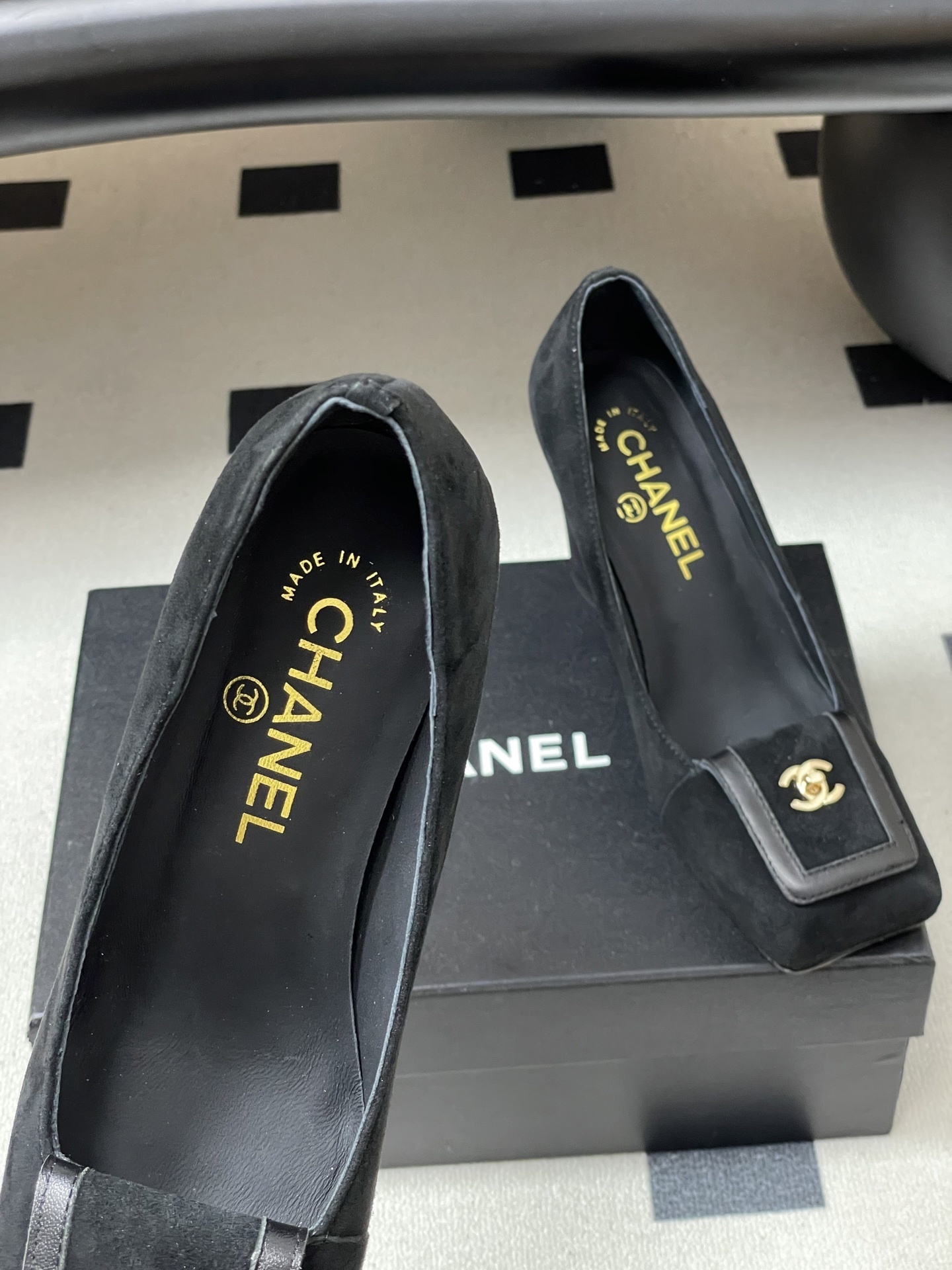 A pair of luxury Chanel black suede square-toe pumps featuring gold CC logo buckles and block heels. - Hình 7