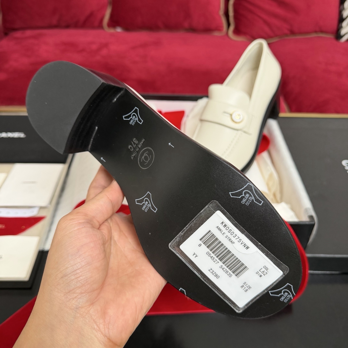 Pair of cream Chanel leather loafers with gold CC logo button and black block heel in original luxury packaging - Hình 9