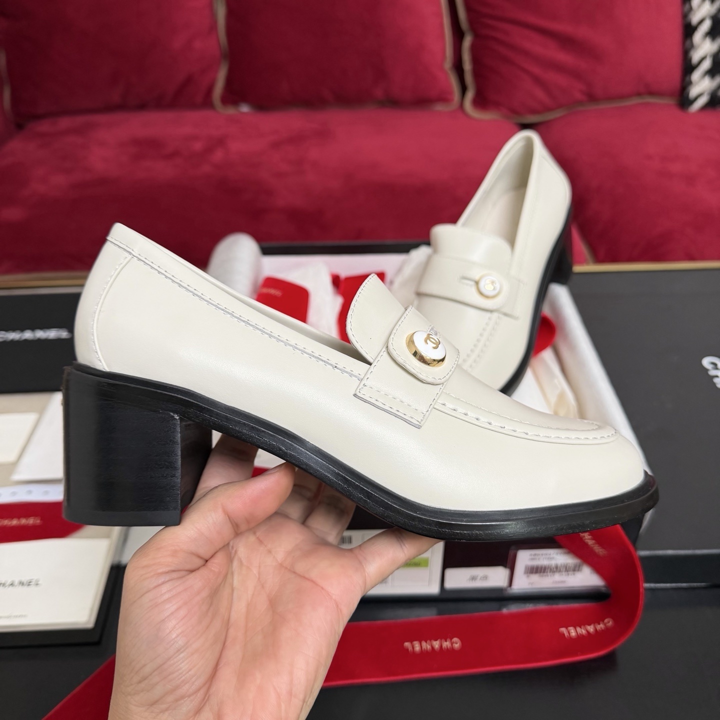 Pair of cream Chanel leather loafers with gold CC logo button and black block heel in original luxury packaging - Hình 5