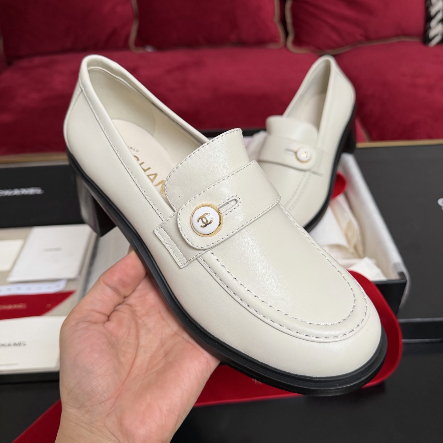 Pair of cream Chanel leather loafers with gold CC logo button and black block heel in original luxury packaging - Hình 4