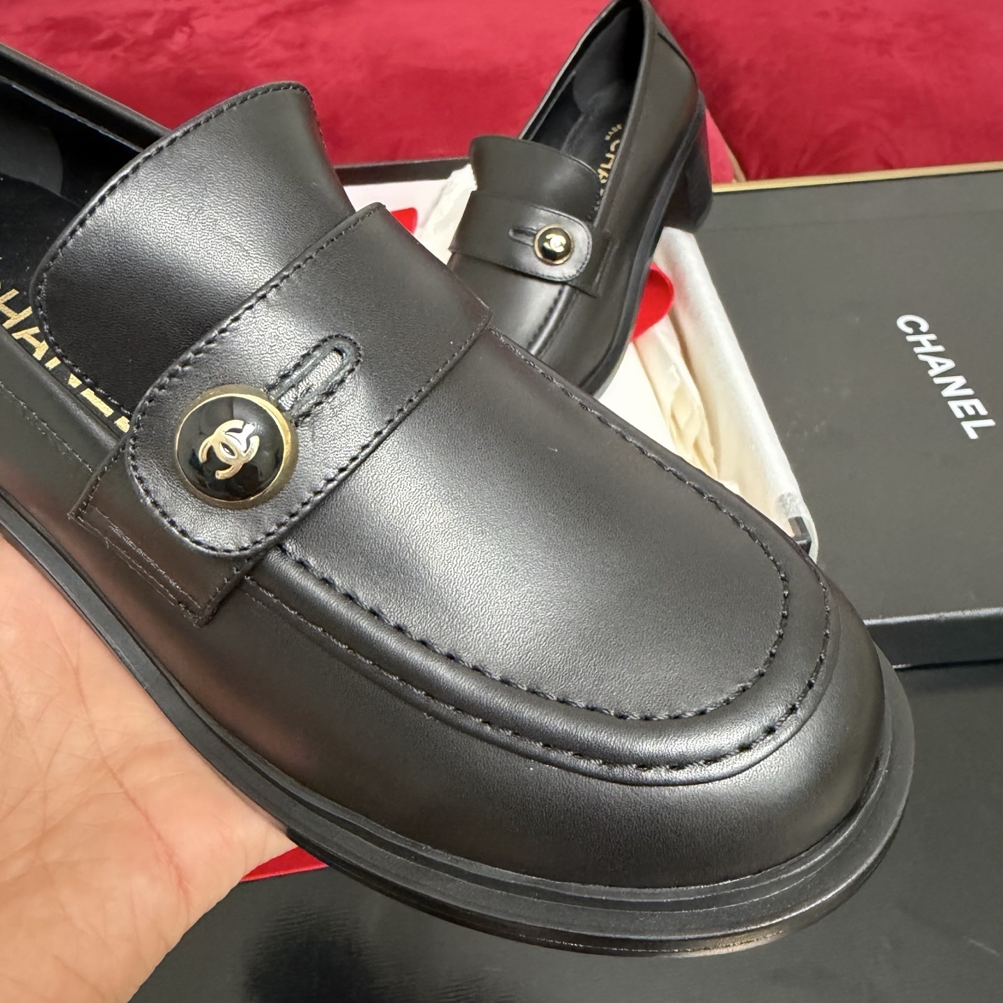 Authentic Chanel black leather loafers with block heels and gold CC logo buttons displayed in a box - Hình 6