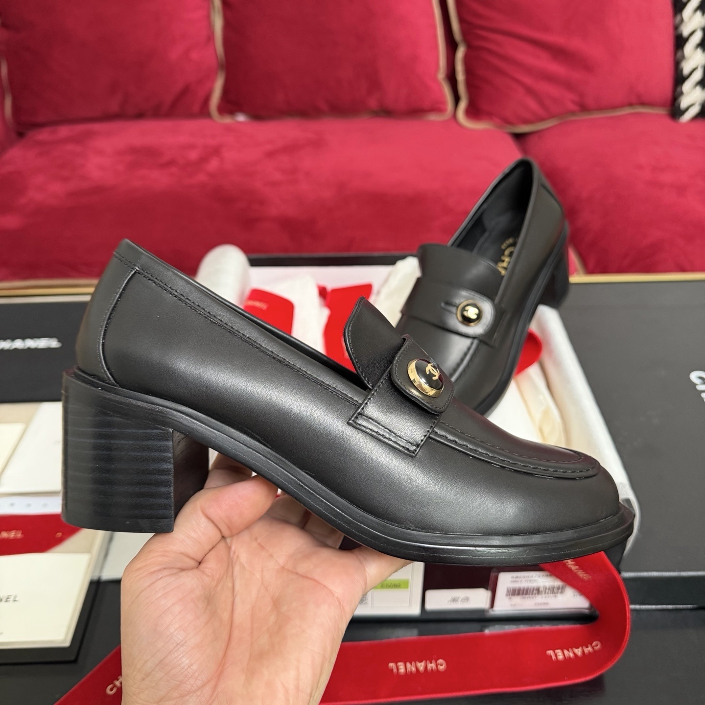 Authentic Chanel black leather loafers with block heels and gold CC logo buttons displayed in a box - Hình 5