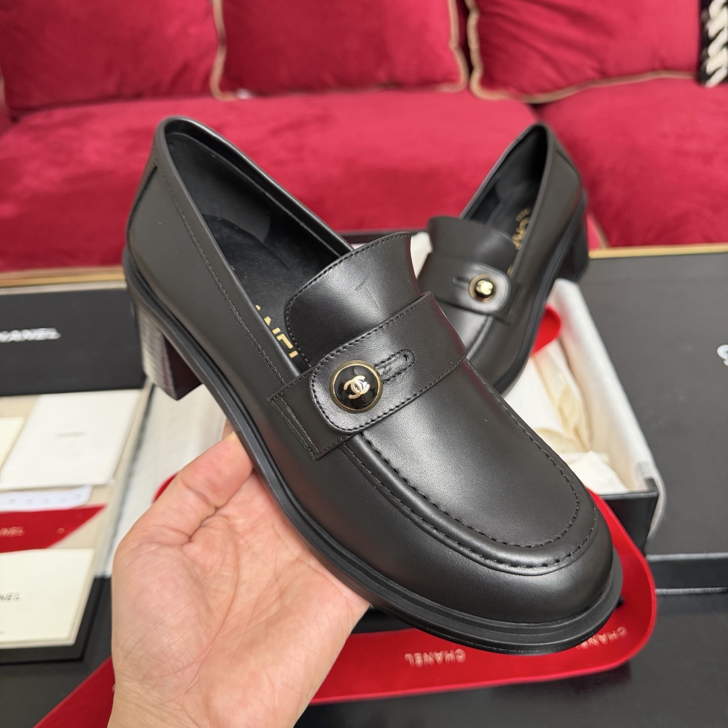 Authentic Chanel black leather loafers with block heels and gold CC logo buttons displayed in a box - Hình 4