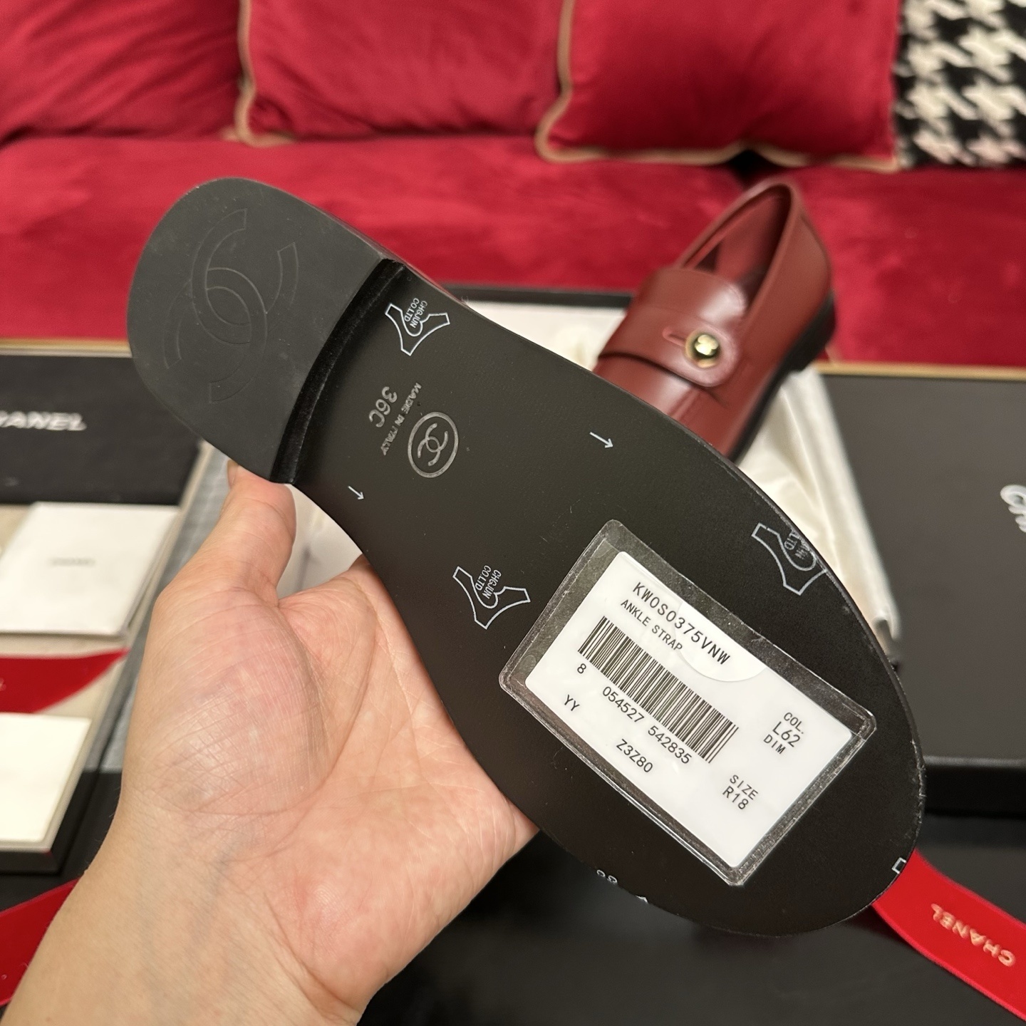 Luxury Chanel burgundy leather loafers with gold CC logo button displayed with designer packaging and red ribbons - Hình 9