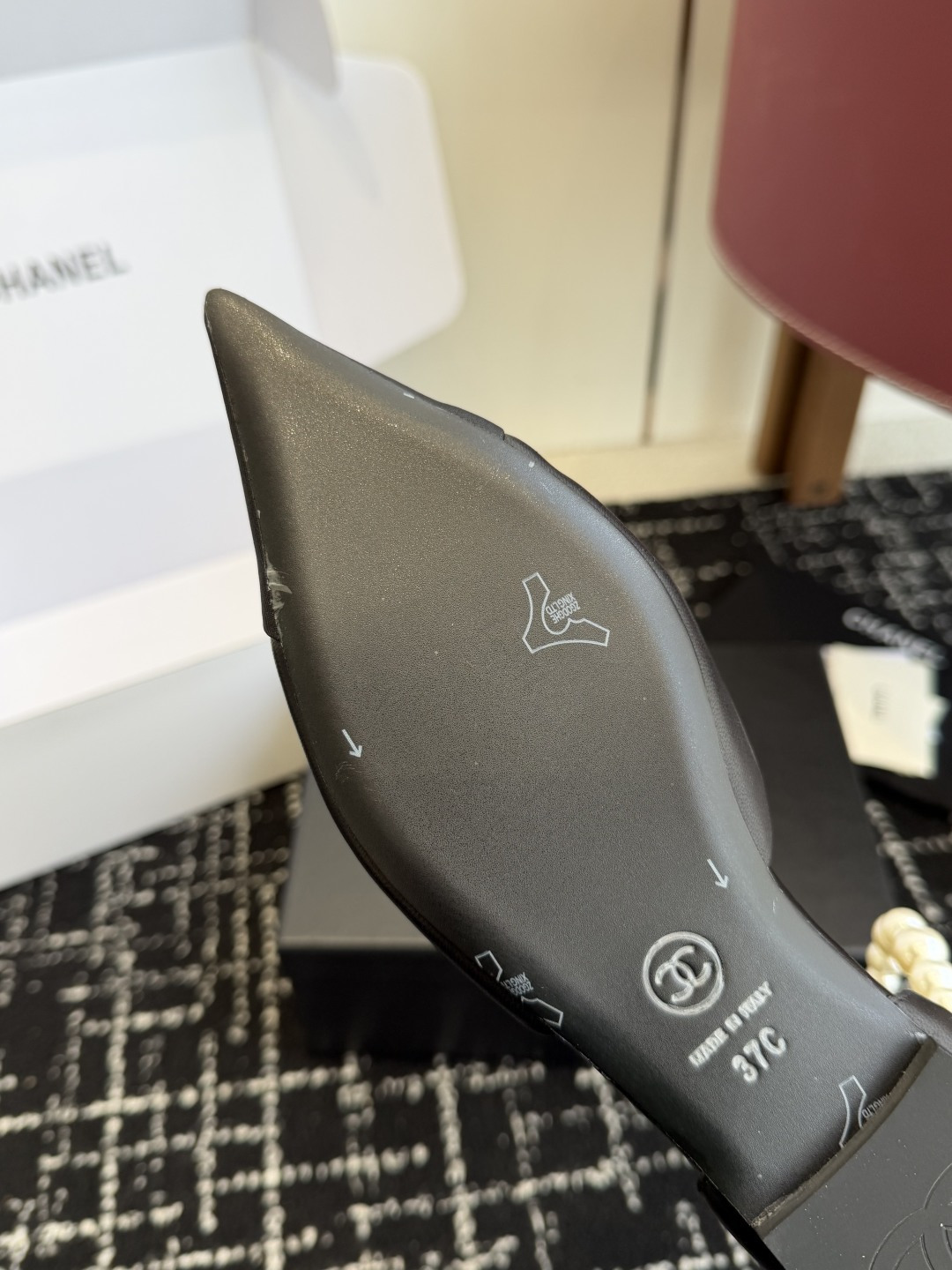 Pair of black Chanel leather pointed-toe flats featuring double pearl ankle straps and black camellia flower details with gold CC logo. - Hình 9