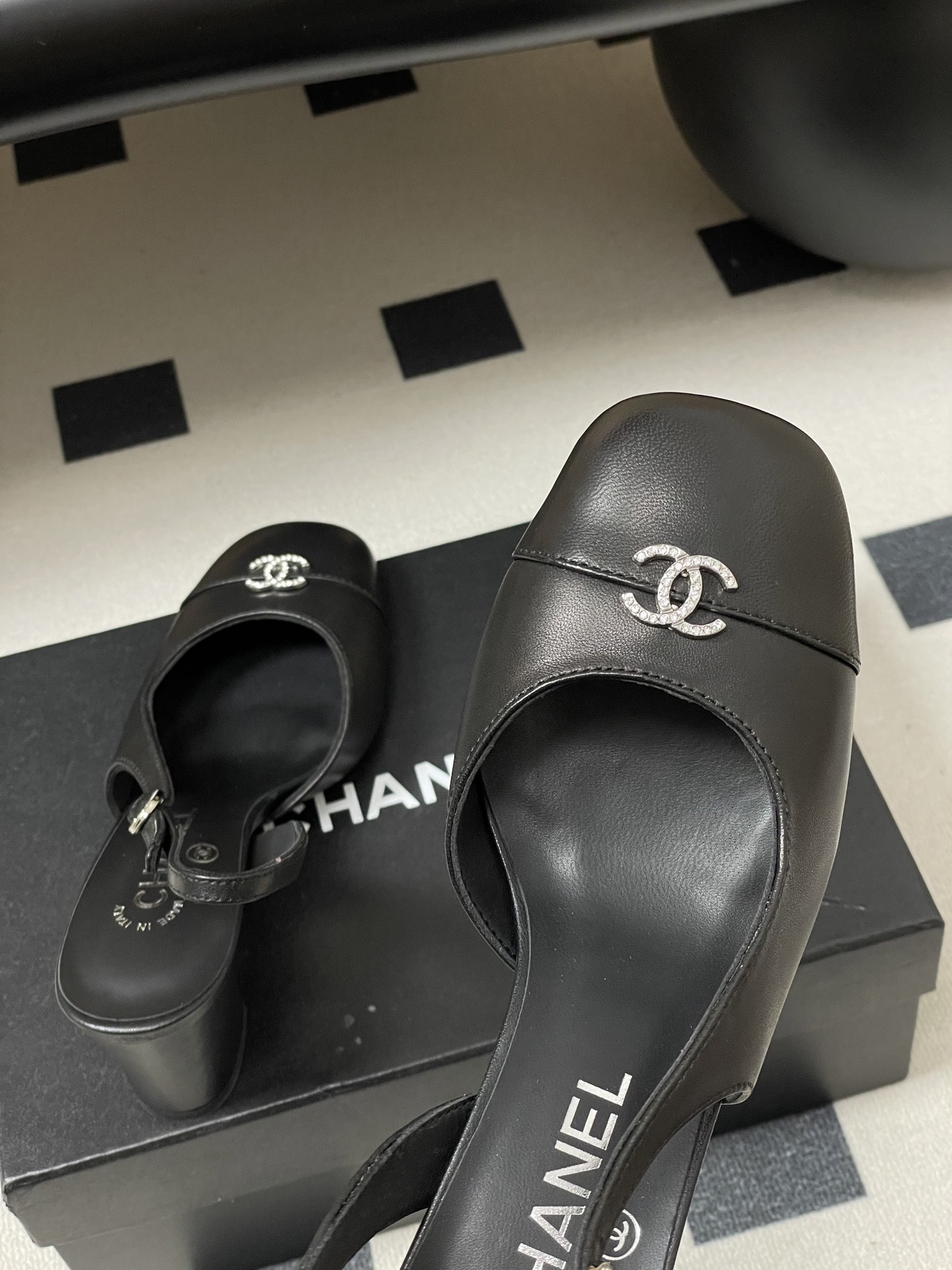 A pair of luxury black leather Chanel slingback pumps with crystal CC logos on the toes and block heels. - Hình 9