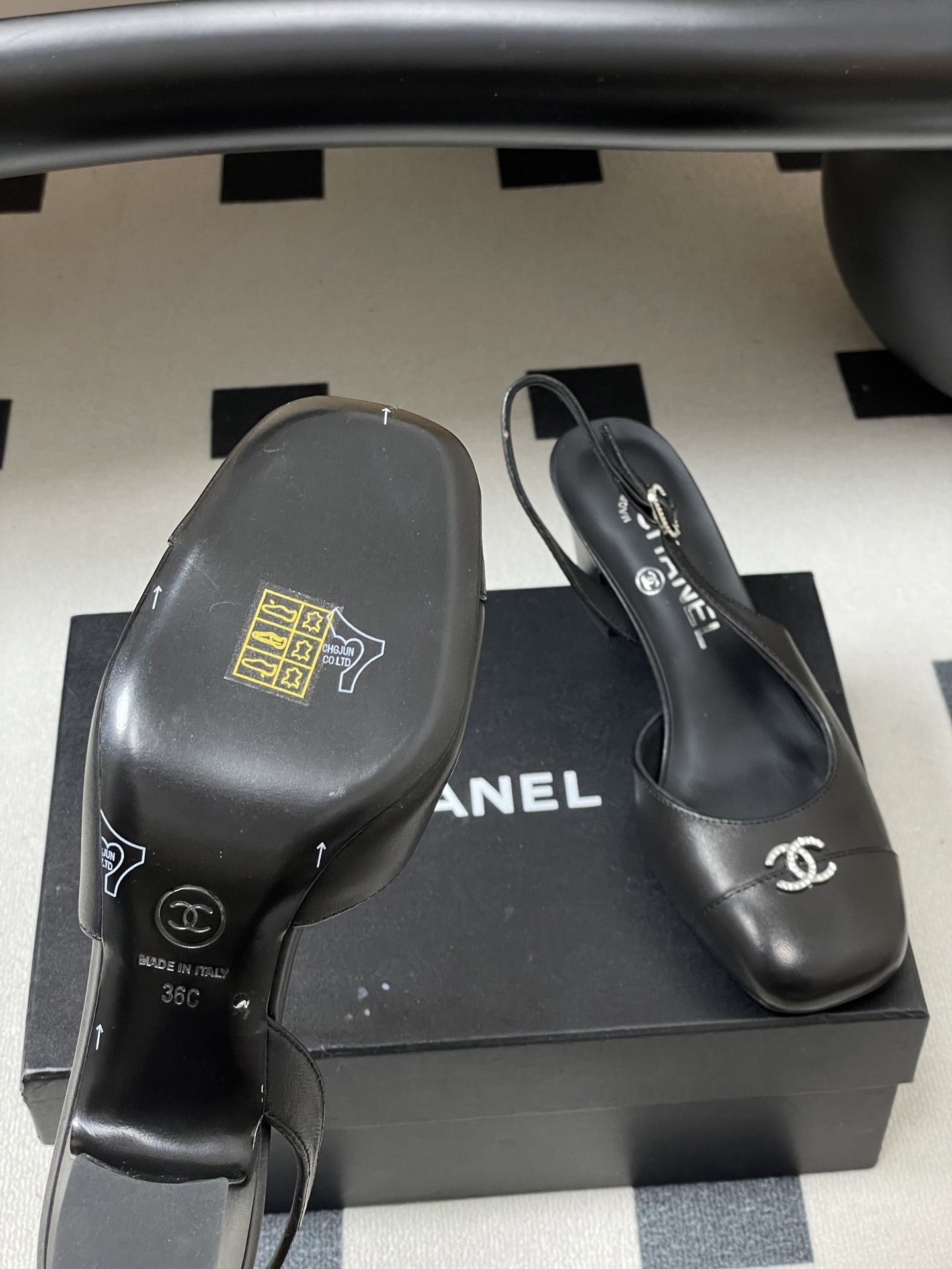 A pair of luxury black leather Chanel slingback pumps with crystal CC logos on the toes and block heels. - Hình 8