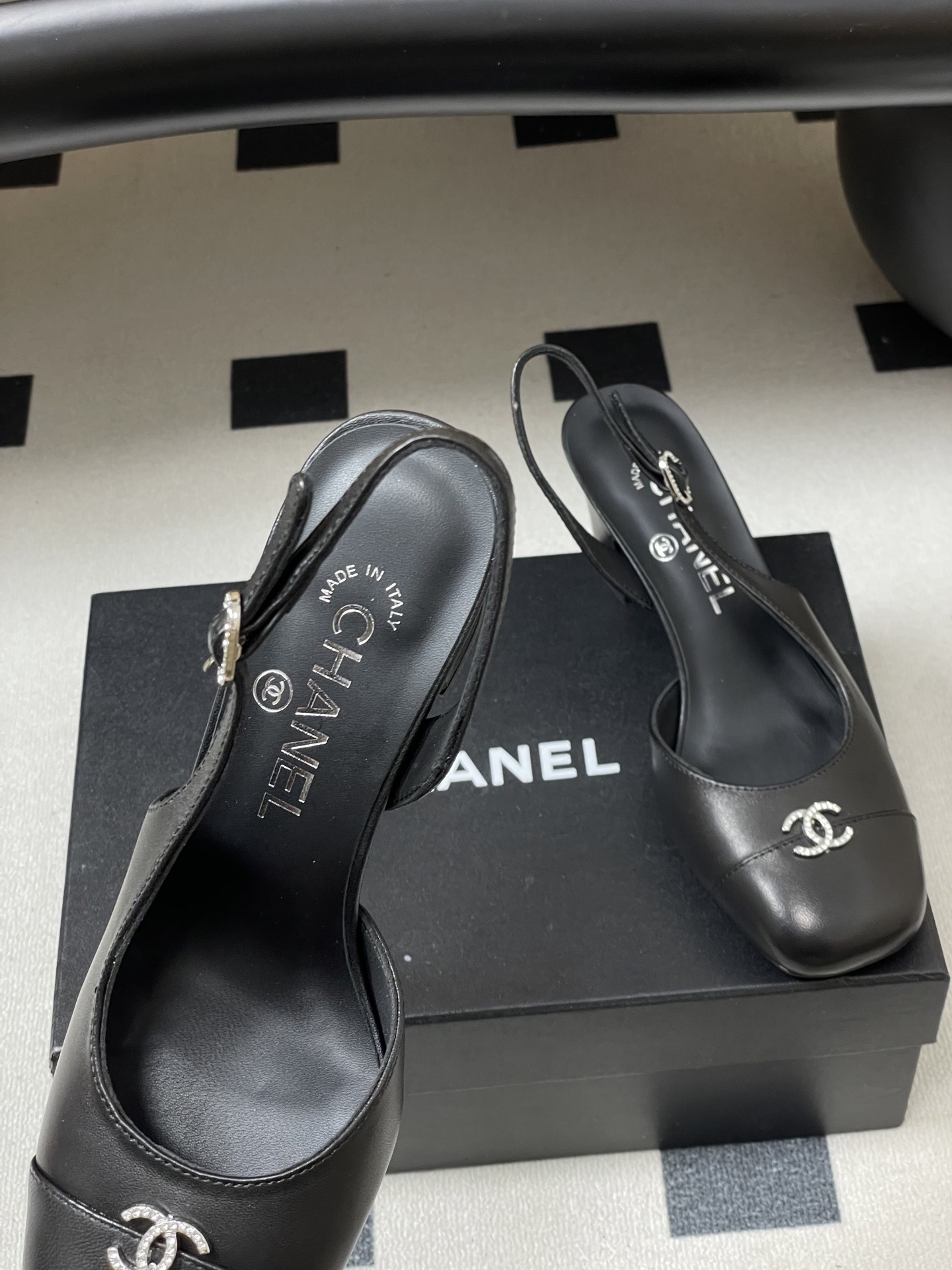A pair of luxury black leather Chanel slingback pumps with crystal CC logos on the toes and block heels. - Hình 7
