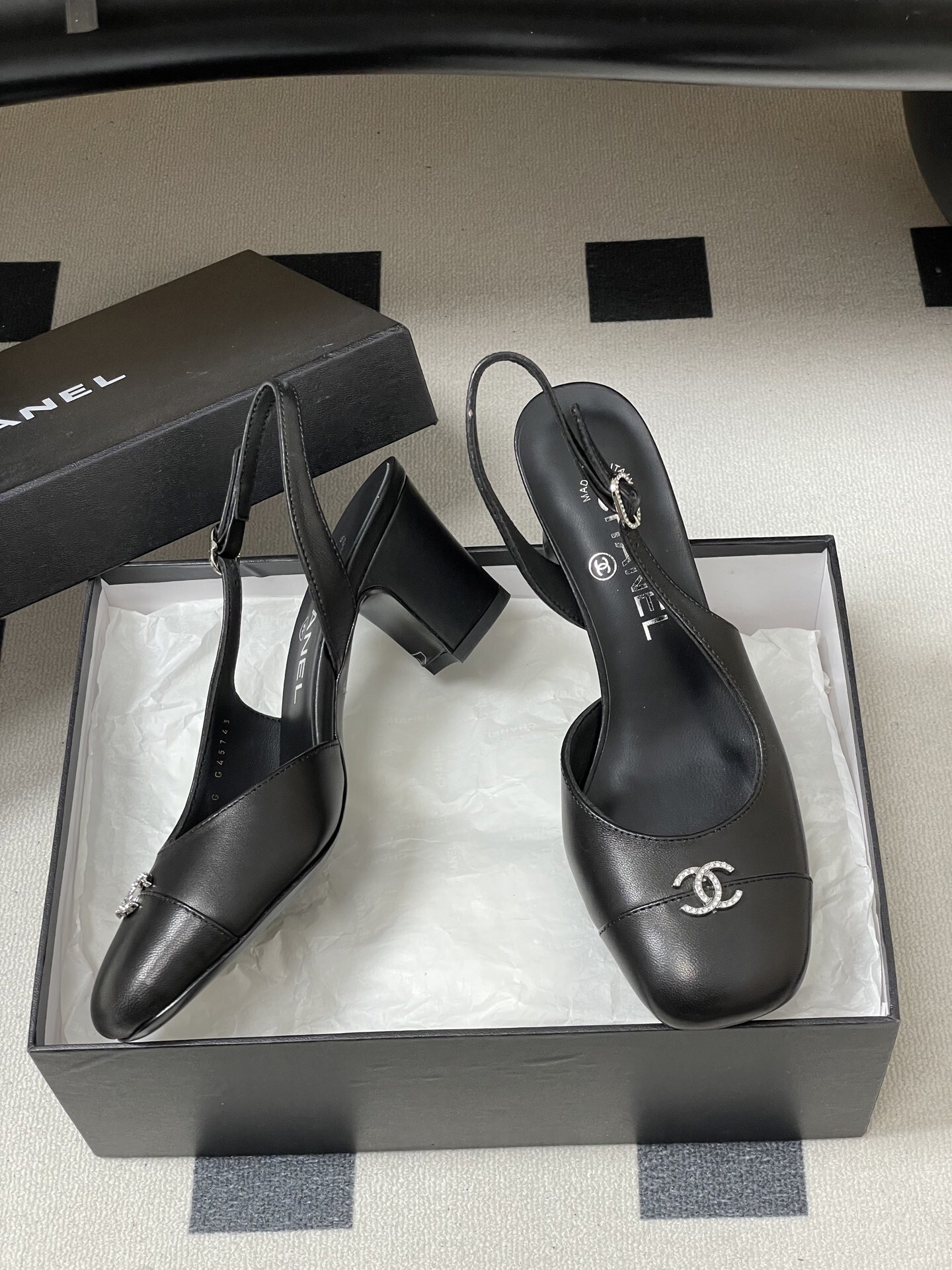 A pair of luxury black leather Chanel slingback pumps with crystal CC logos on the toes and block heels. - Hình 6