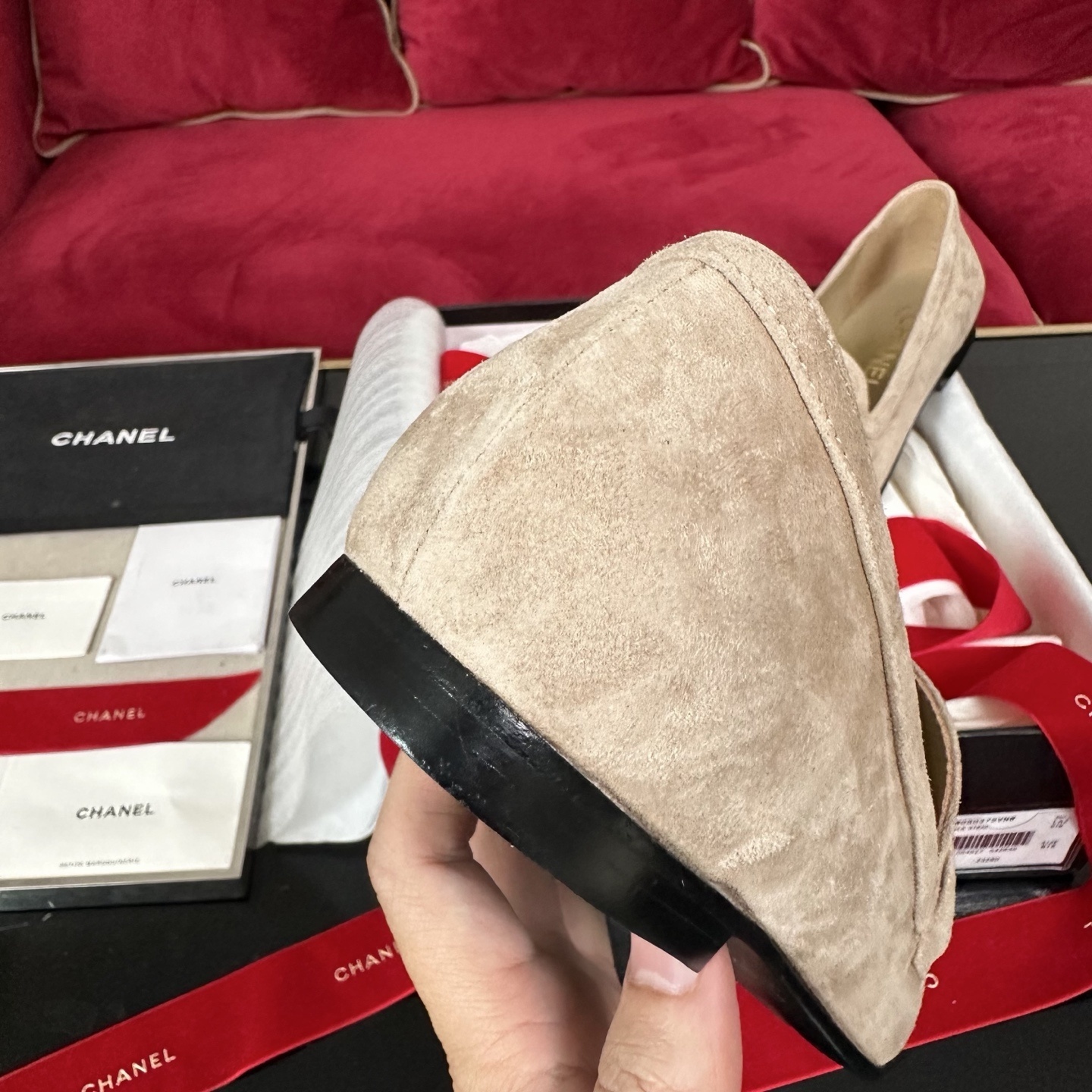Luxury Chanel beige suede loafers featuring a gold crystal-encrusted CC logo, displayed with original black box and red ribbons. - Hình 8