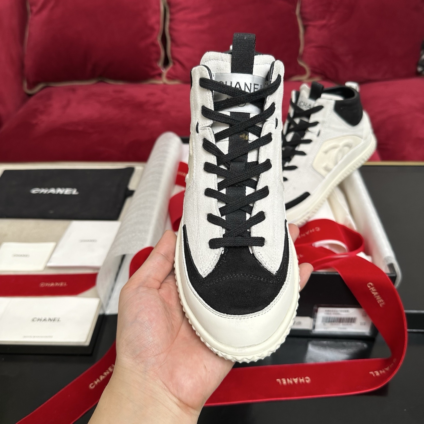 Pair of Chanel high-top sneakers in white and black suede with CC logo and original packaging. - Hình 3