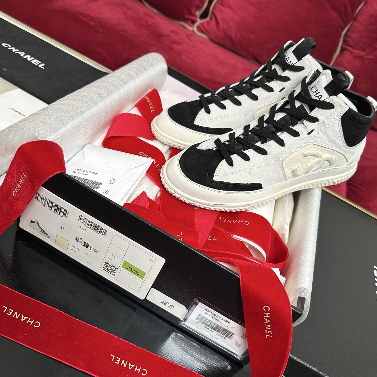 Pair of Chanel high-top sneakers in white and black suede with CC logo and original packaging. - Hình 2