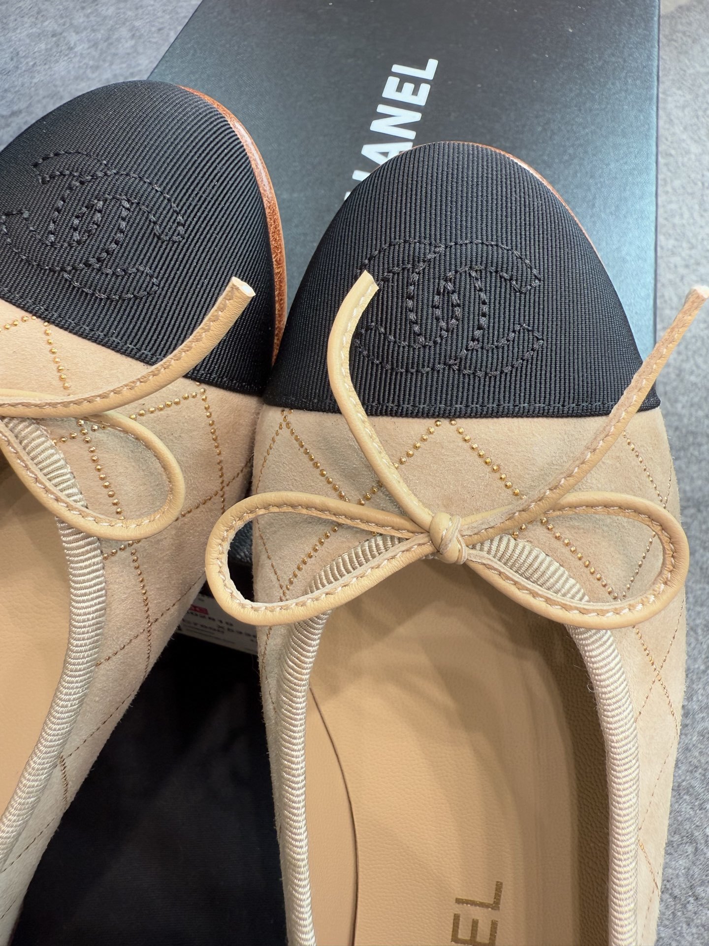 A pair of beige Chanel quilted lambskin ballerina flats with black cap toes and gold stud detailing. - Hình 11