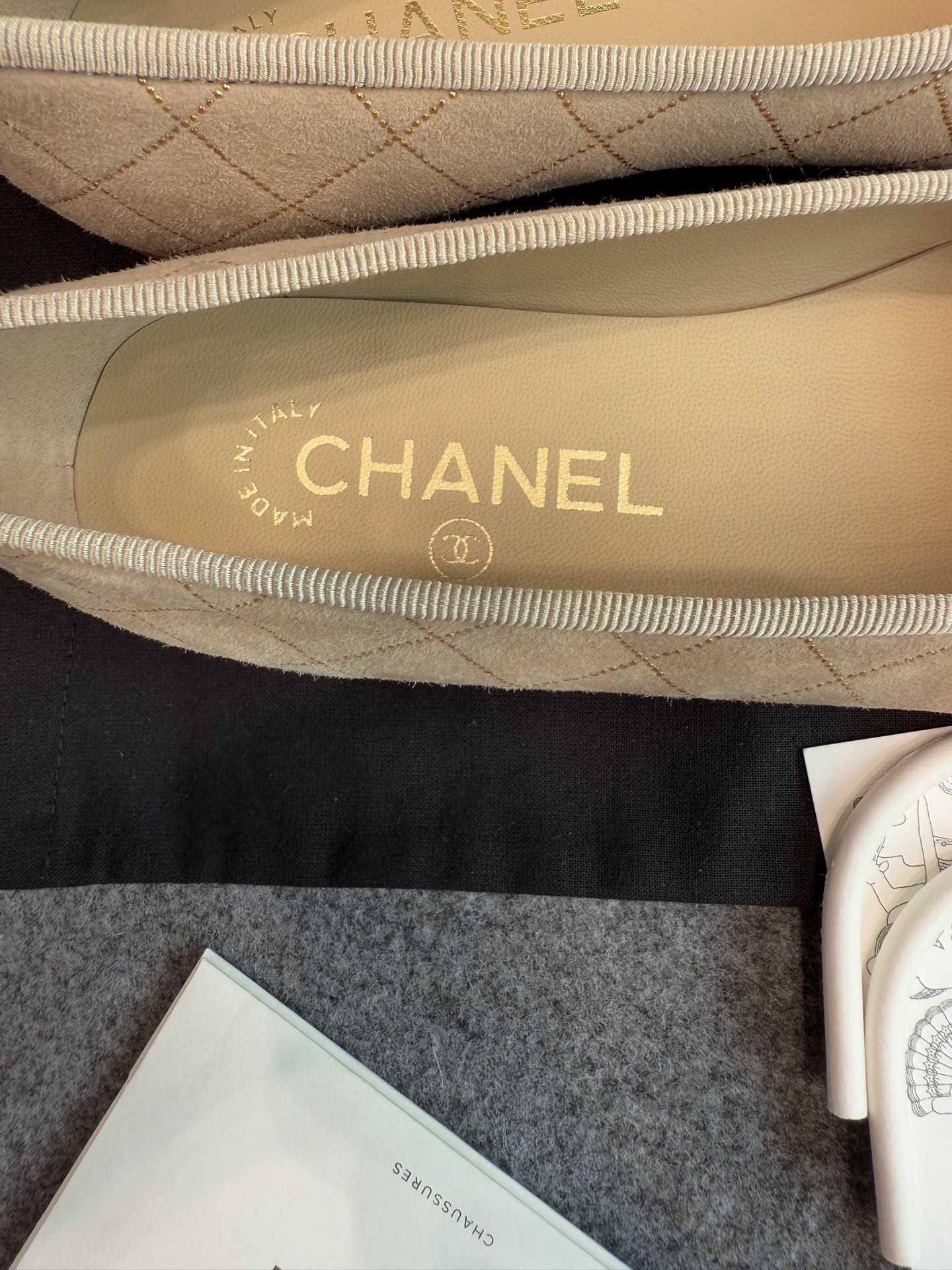 A pair of beige Chanel quilted lambskin ballerina flats with black cap toes and gold stud detailing. - Hình 10