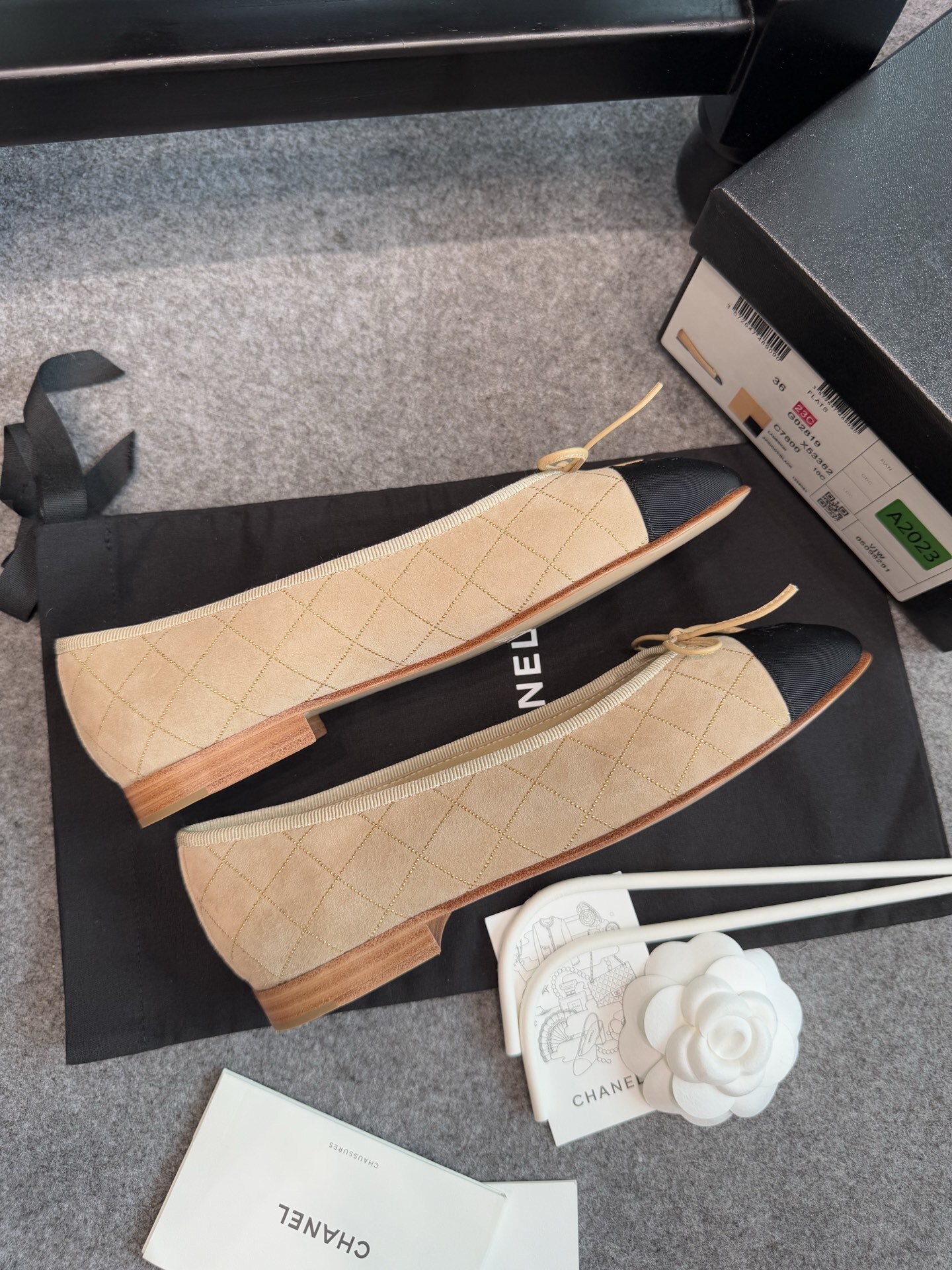 A pair of beige Chanel quilted lambskin ballerina flats with black cap toes and gold stud detailing. - Hình 9