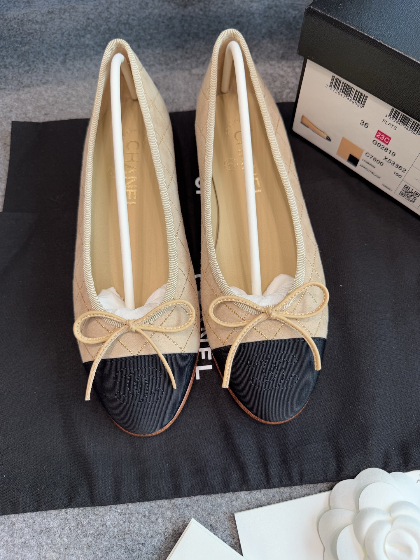 A pair of beige Chanel quilted lambskin ballerina flats with black cap toes and gold stud detailing. - Hình 5