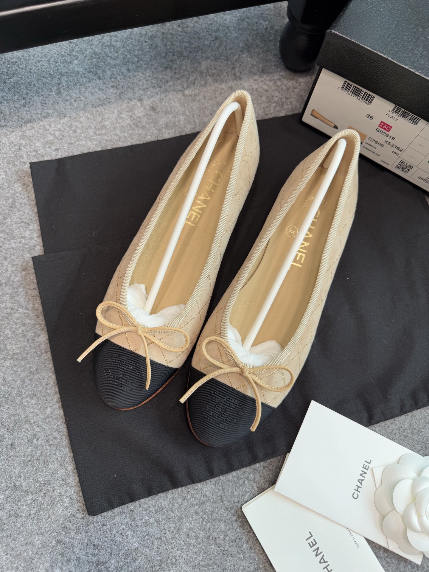 A pair of beige Chanel quilted lambskin ballerina flats with black cap toes and gold stud detailing. - Hình 4