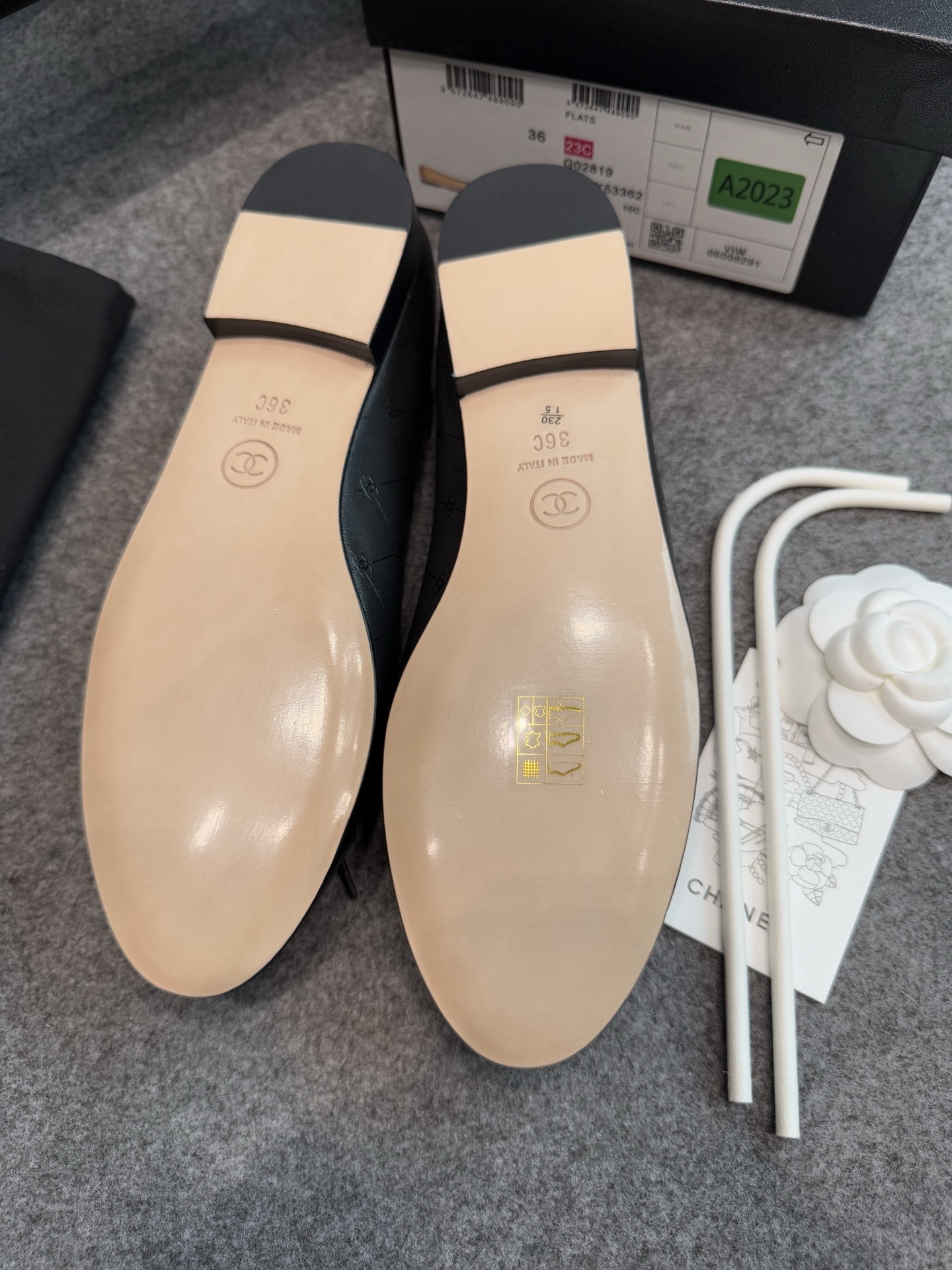 A pair of black Chanel quilted lambskin ballerina flats with patent leather CC toe caps and front bows, displayed with original luxury packaging. - Hình 10