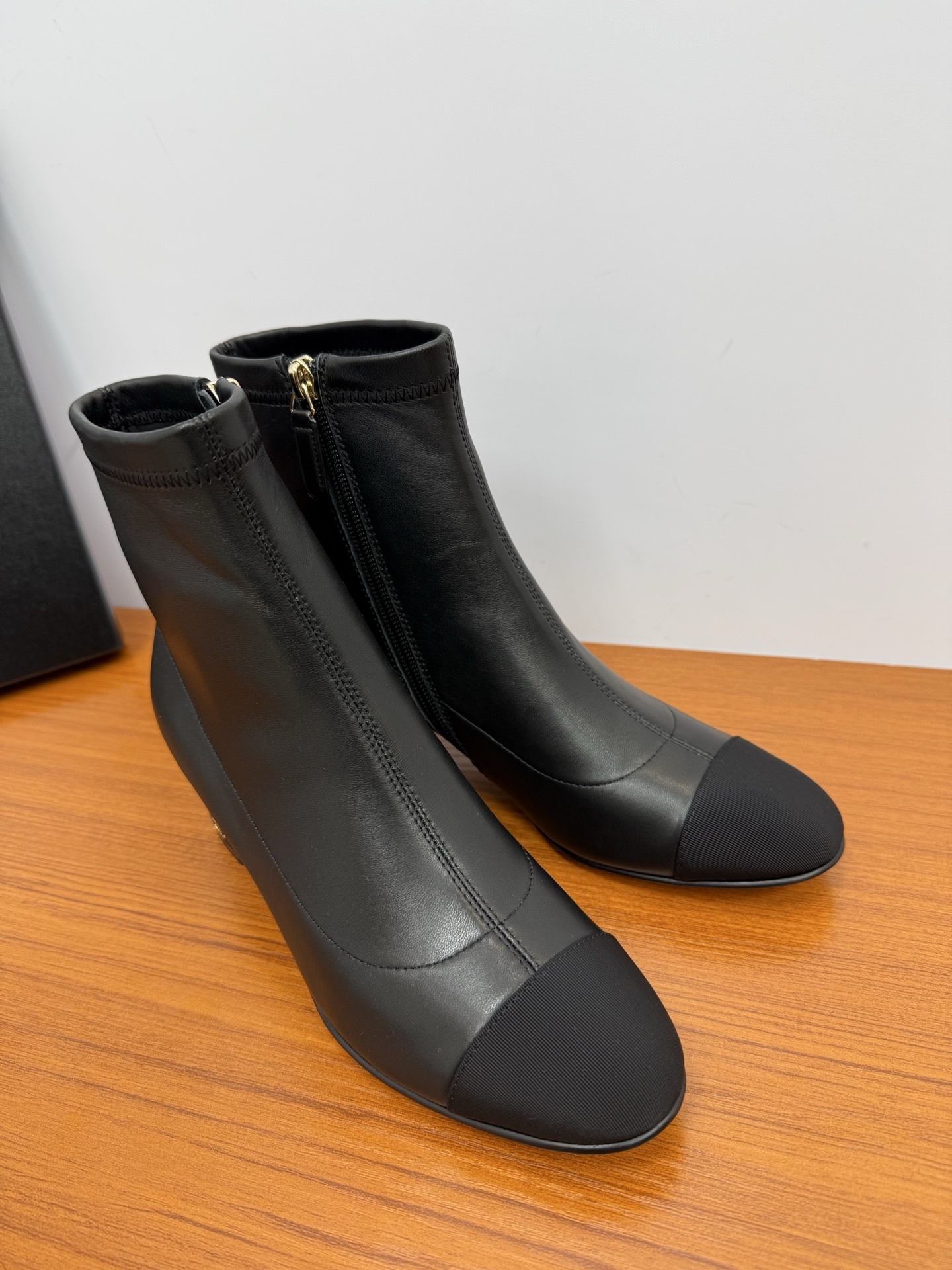 Elegant black leather ankle boots with a fabric cap toe and gold-tone zipper detail - Hình 2