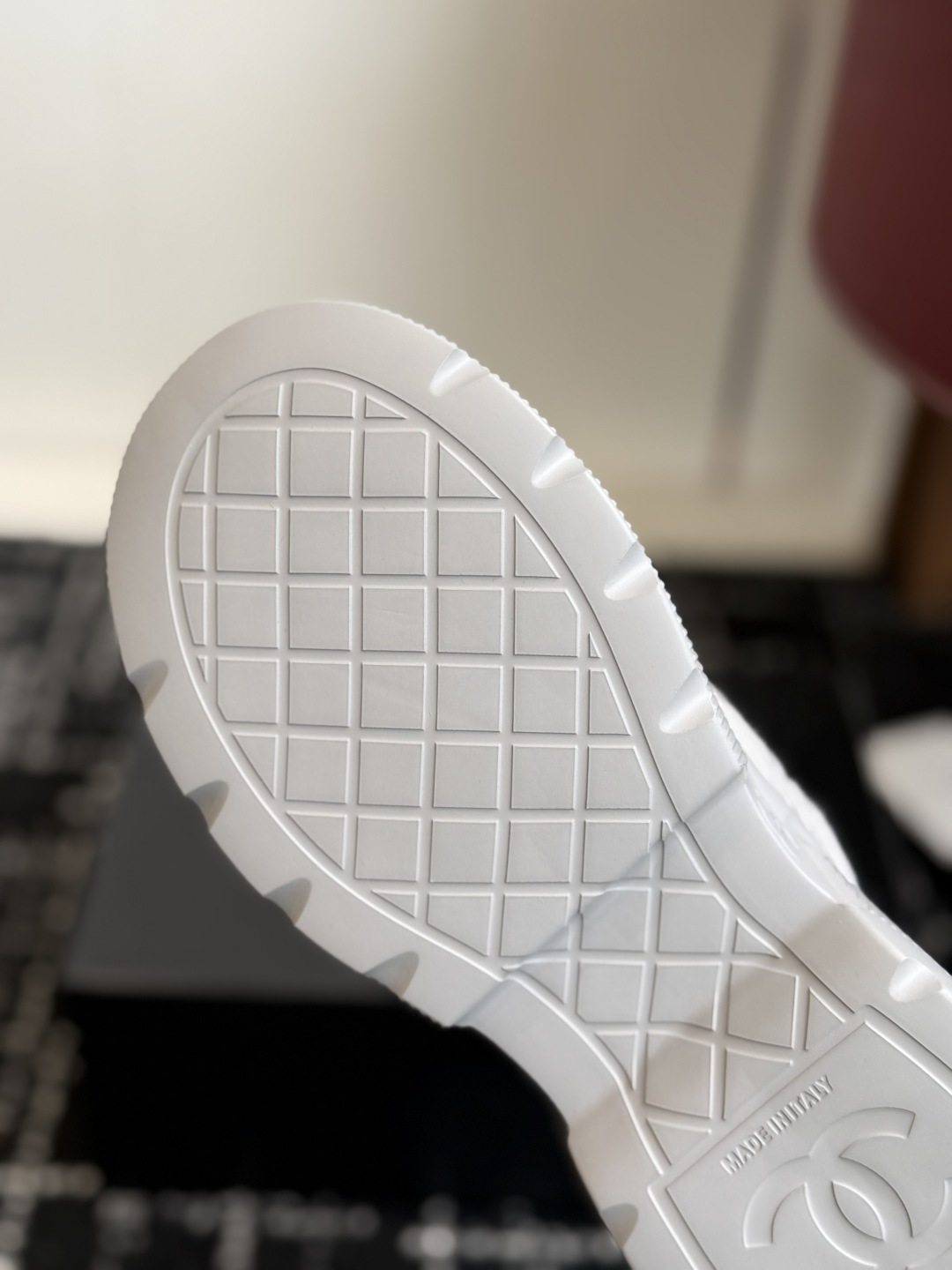 Close-up view of luxury white mesh sneakers with CC logo on the toe and chunky platform sole - Hình 9