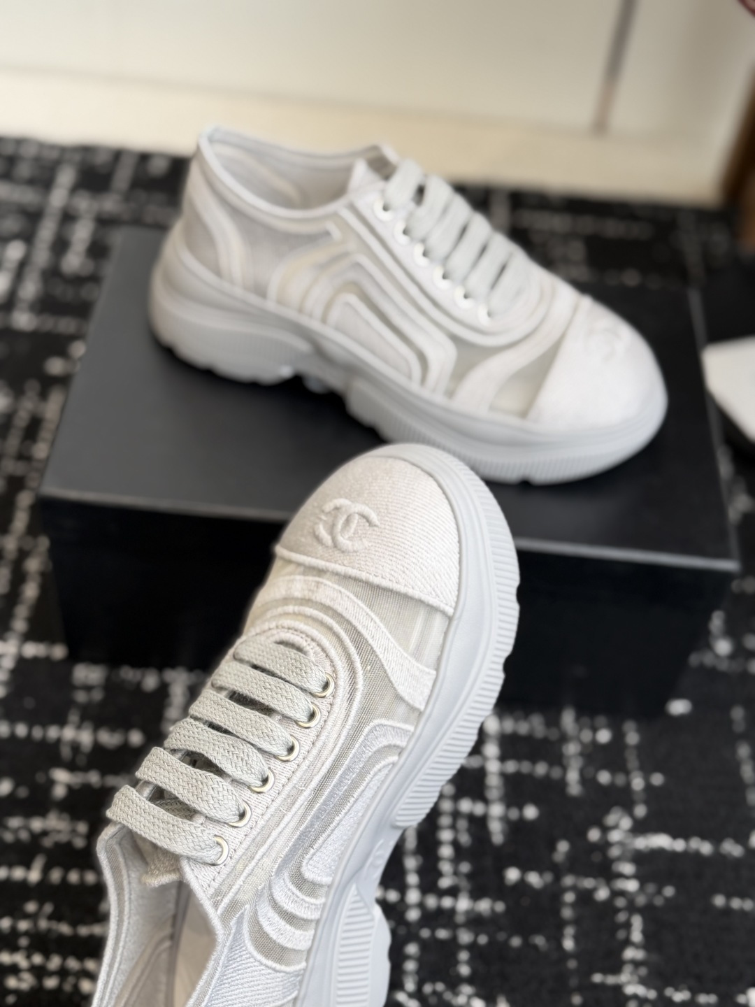 Close-up view of luxury white mesh sneakers with CC logo on the toe and chunky platform sole - Hình 5