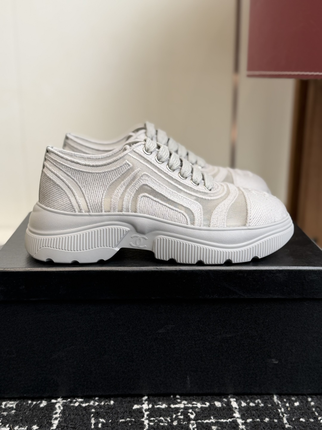 Close-up view of luxury white mesh sneakers with CC logo on the toe and chunky platform sole - Hình 2