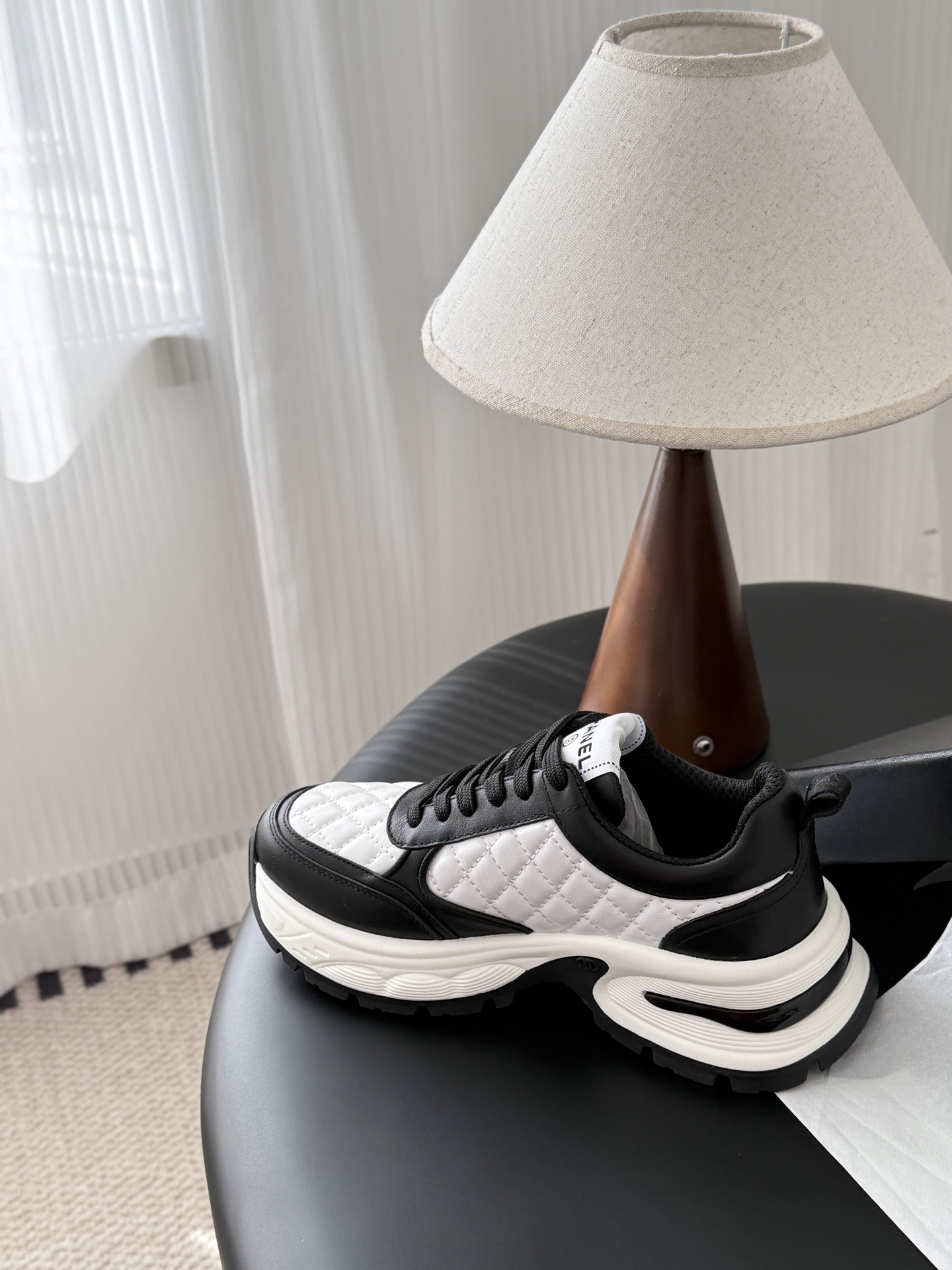 Pair of luxury Chanel women's sneakers in black and white quilted leather with chunky soles and CC logo. - Hình 8