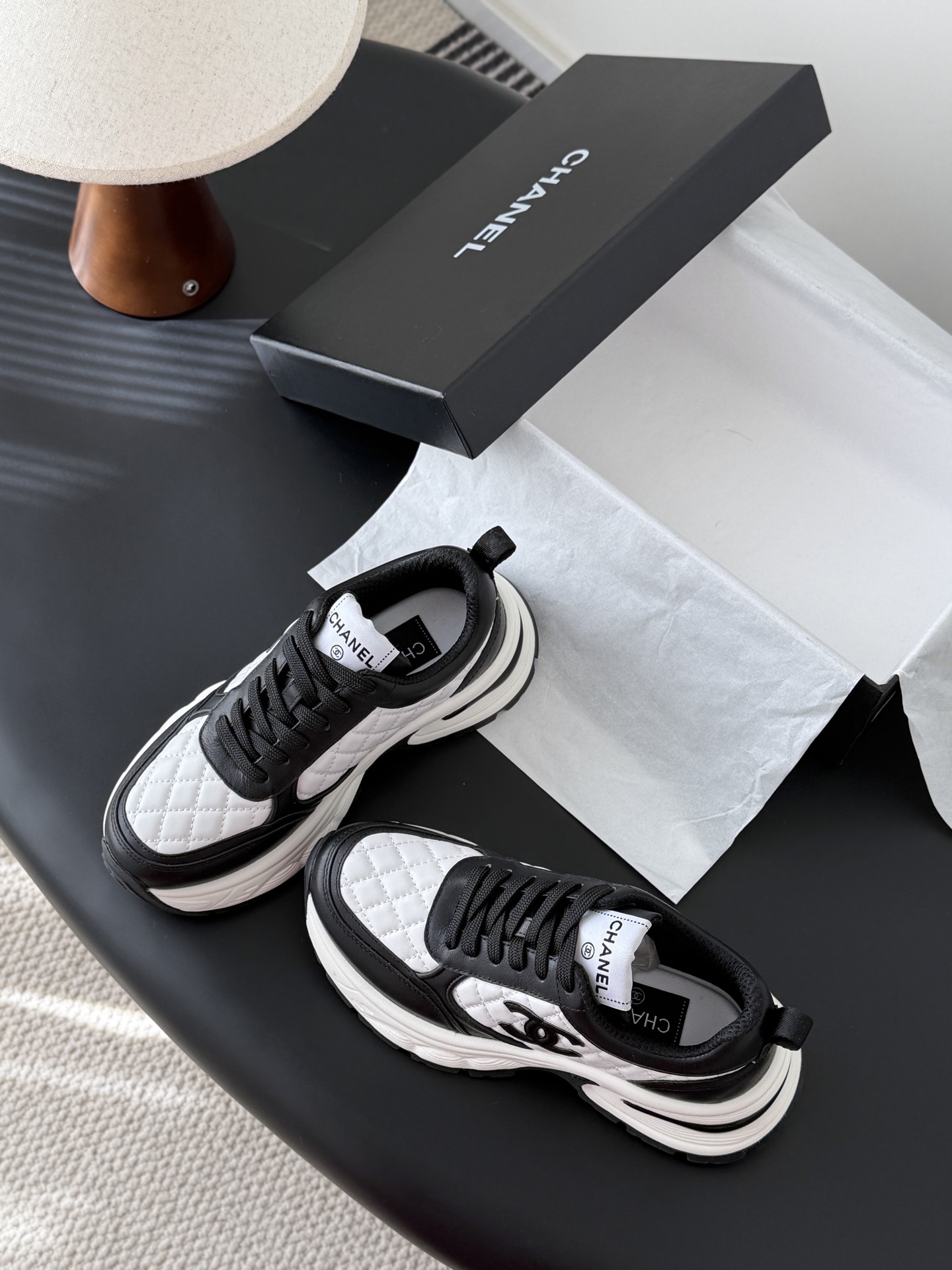 Pair of luxury Chanel women's sneakers in black and white quilted leather with chunky soles and CC logo. - Hình 6