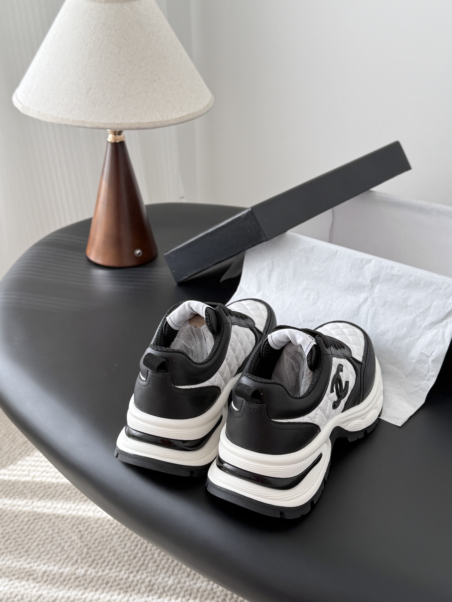 Pair of luxury Chanel women's sneakers in black and white quilted leather with chunky soles and CC logo. - Hình 3