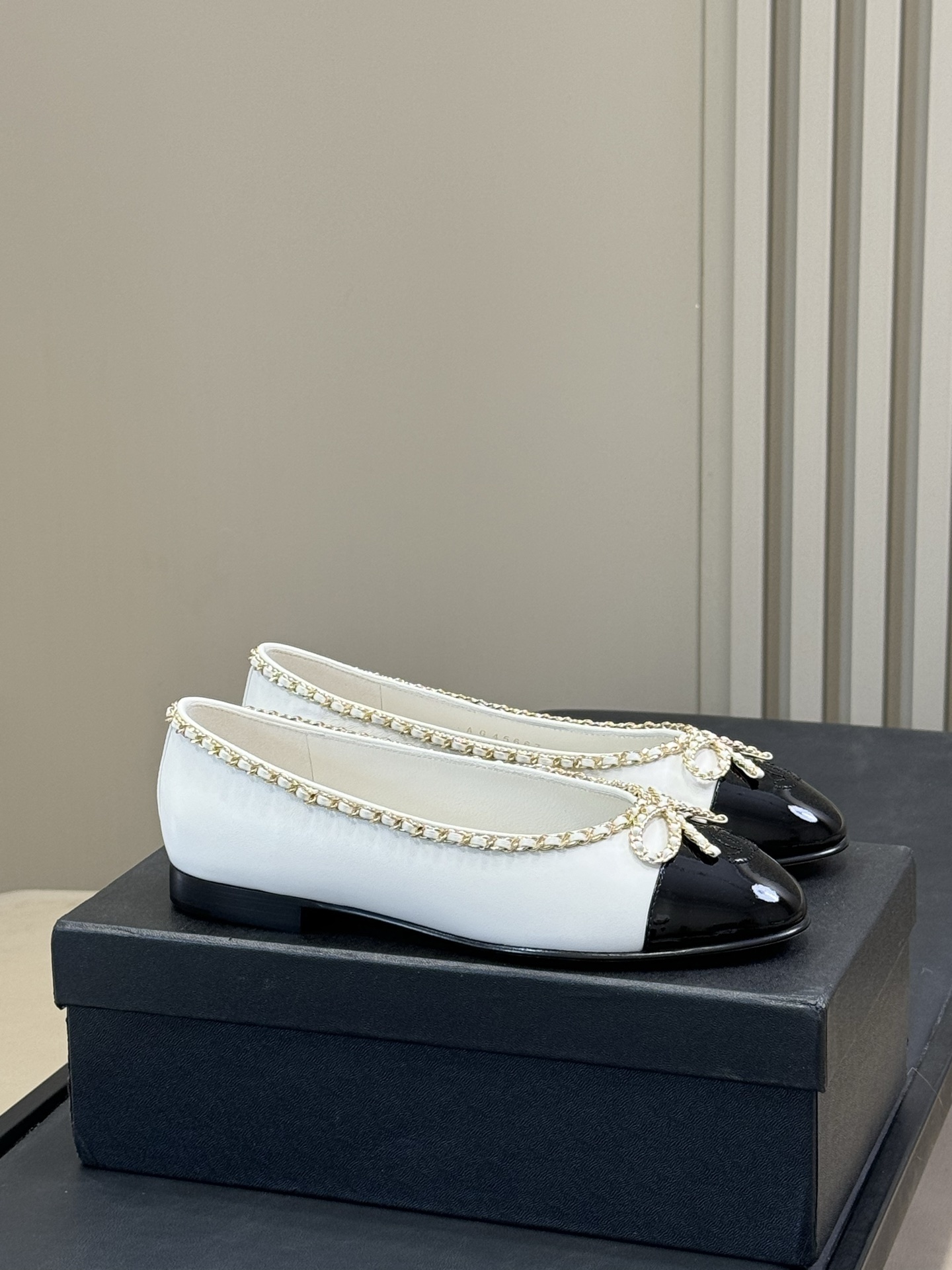 Luxury Chanel Two-Tone Leather Ballet Flats with Gold Chain Detail