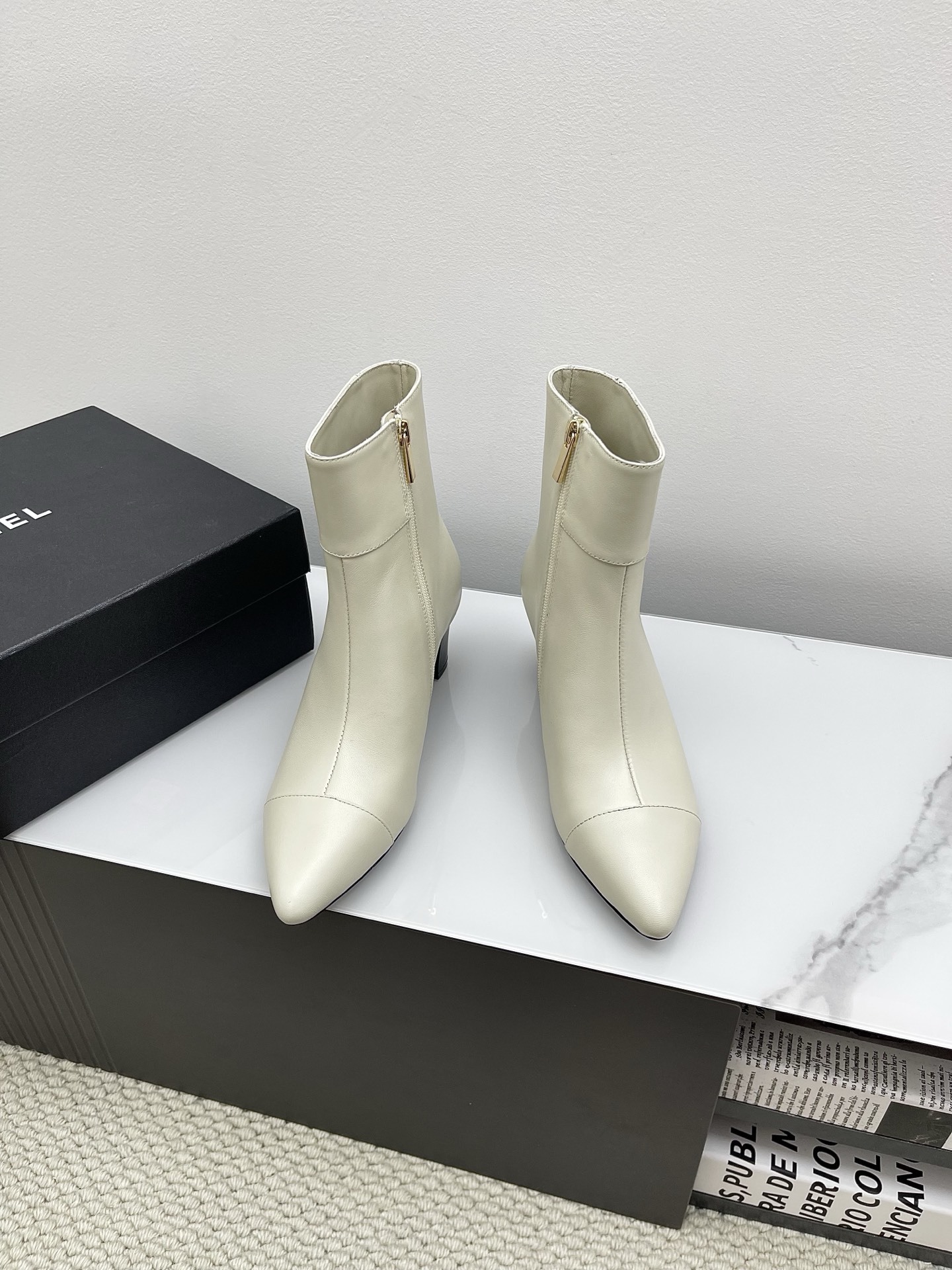 Chic Cream Leather Pointed Toe Ankle Boots with Gold Lion Emblem