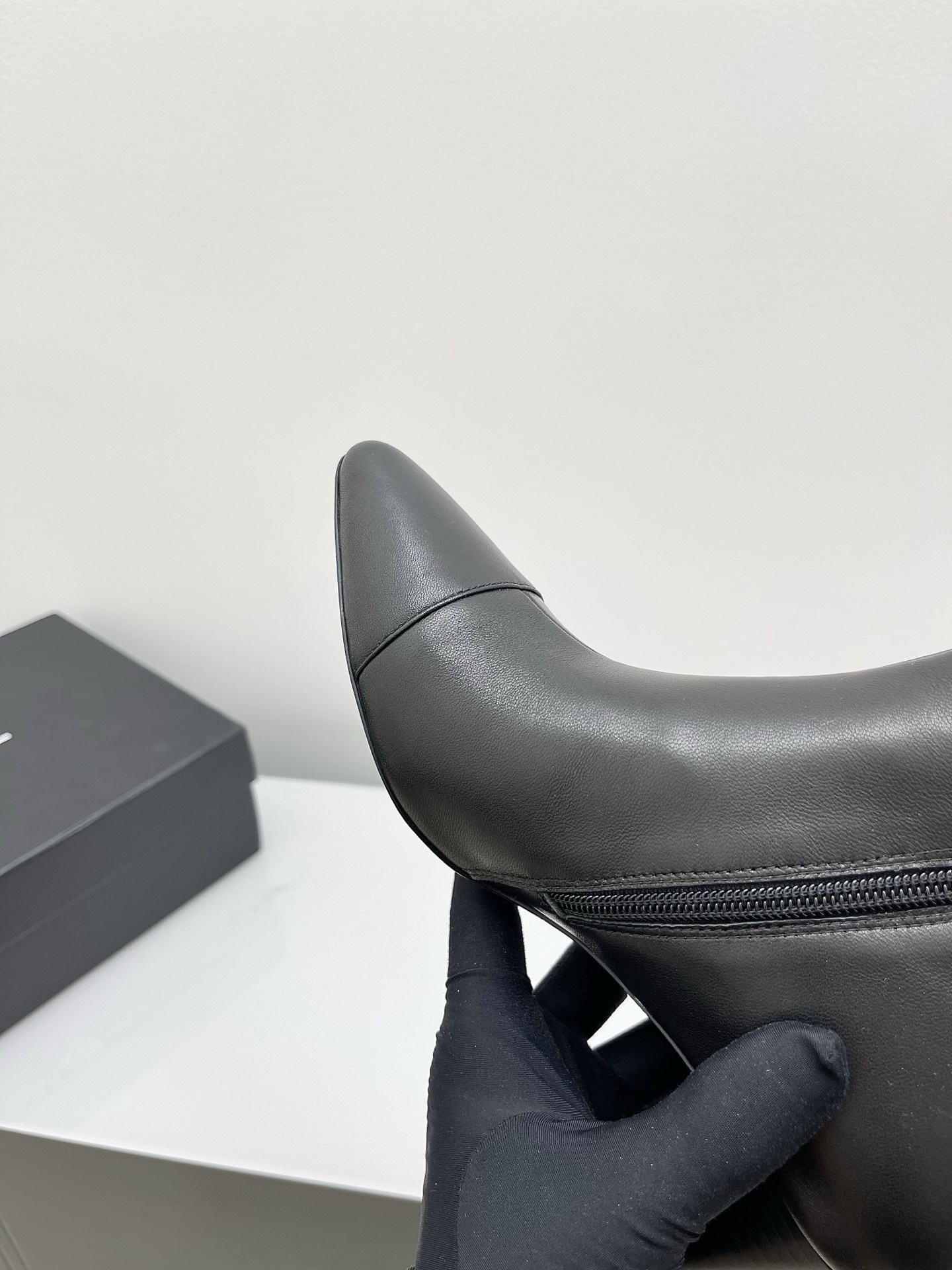 Chanel black leather pointed-toe ankle boots with side zippers and block heels shown next to a signature Chanel box. - Hình 7