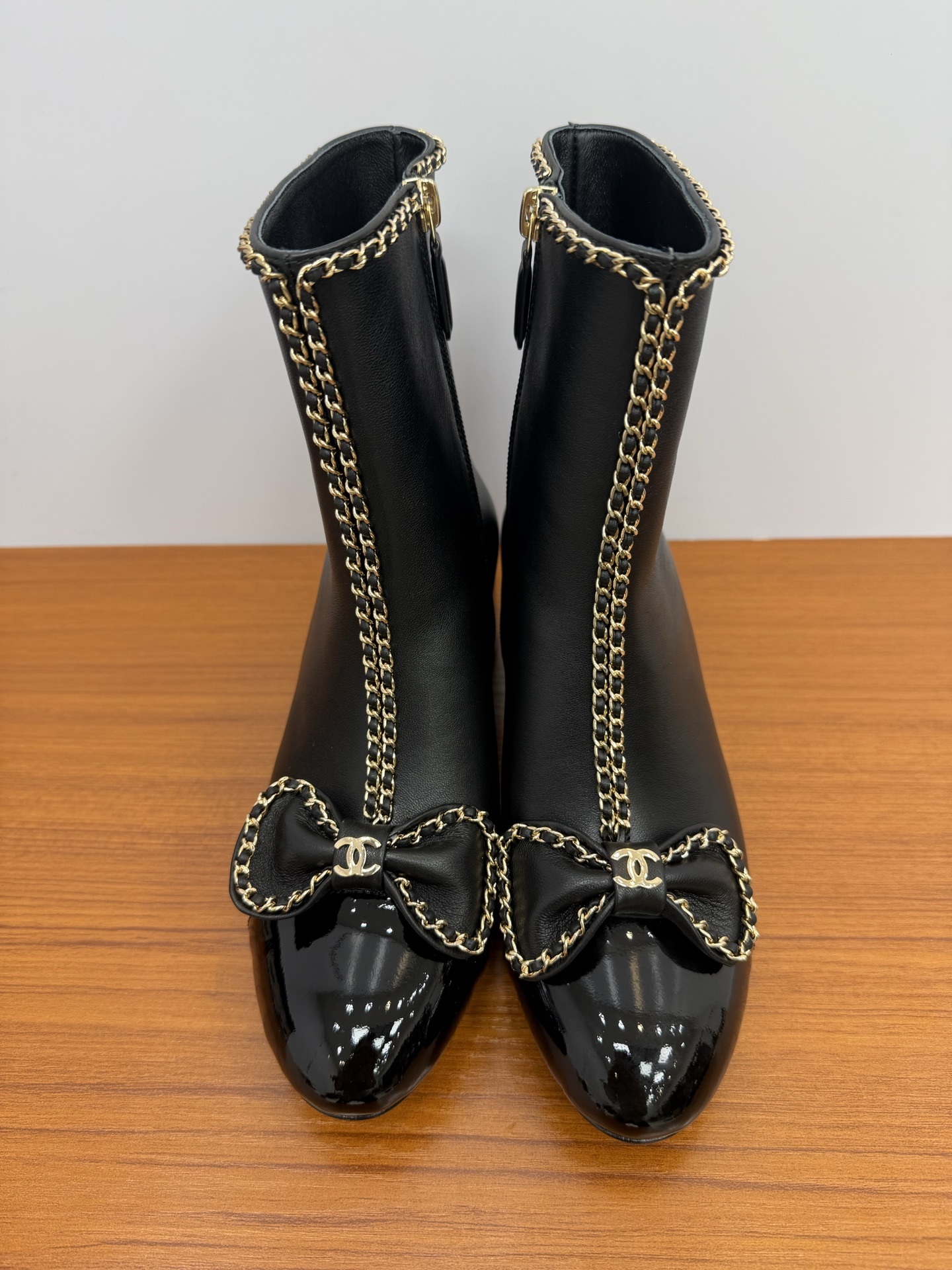 Chanel Black Leather Ankle Boots with Gold Chain and Bow Detail