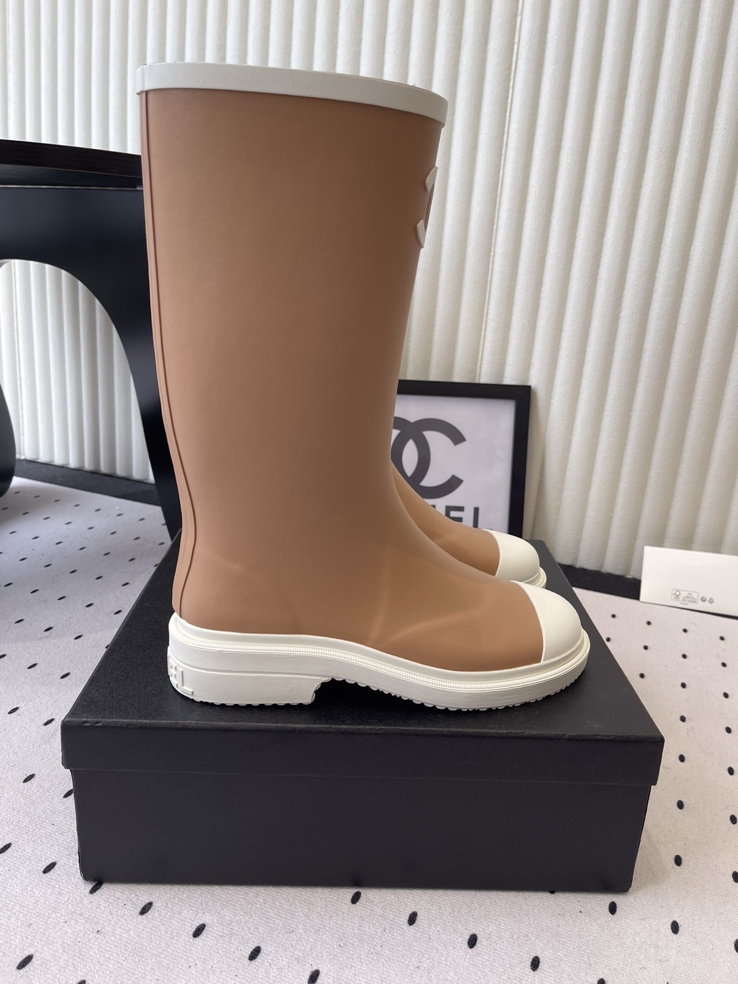 A pair of Chanel tall rain boots in beige and white featuring the CC logo on the front - Hình 2