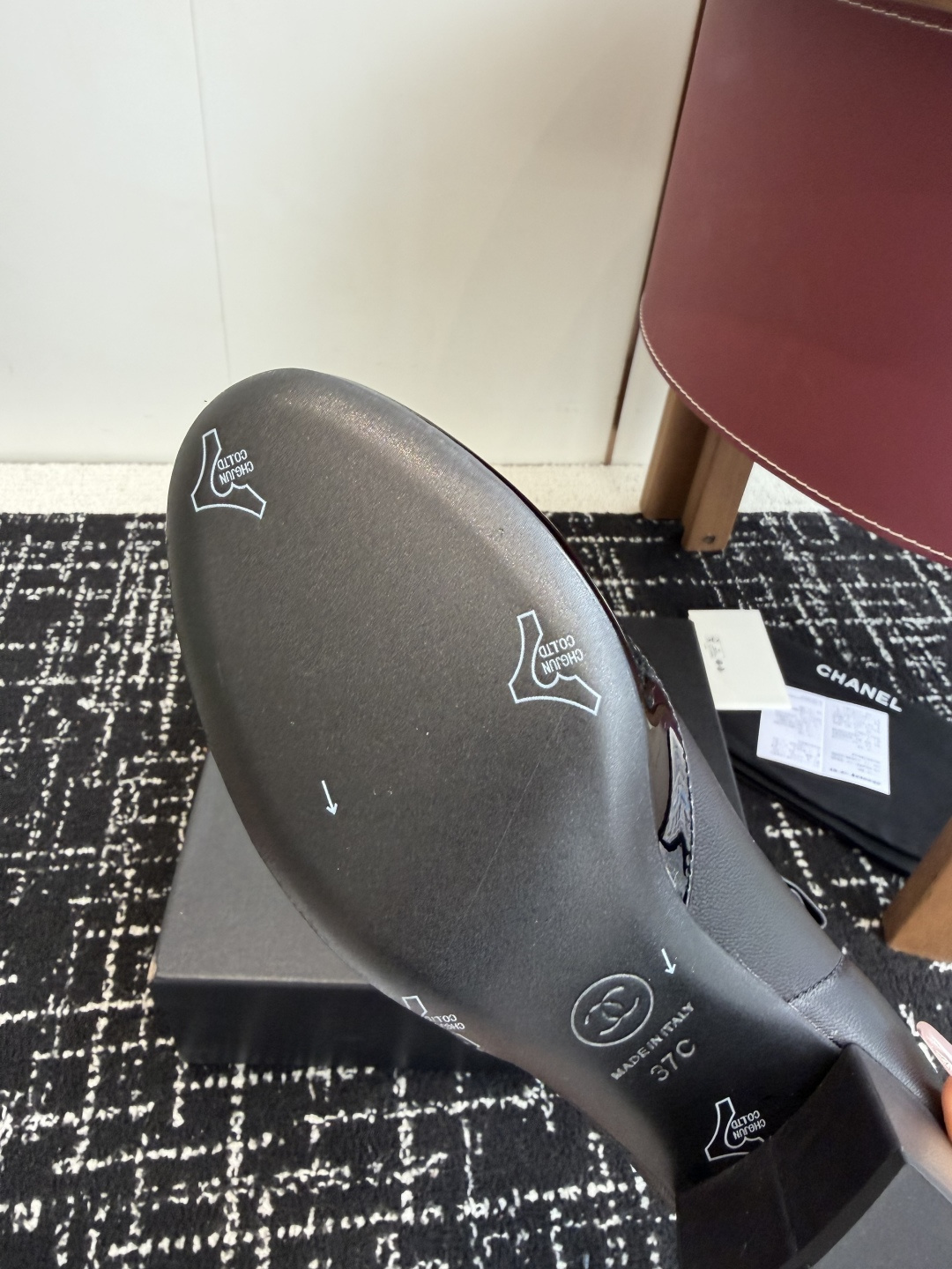 Authentic Chanel black leather ankle boots with ruffle detail and patent toe sitting on a black designer box - Hình 9