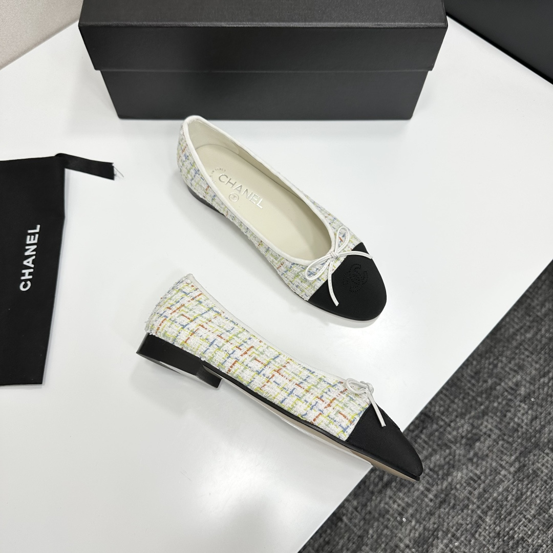 Chanel multi-color tweed ballerina flats with black toe caps and white bows displayed on a black box - Hình 9