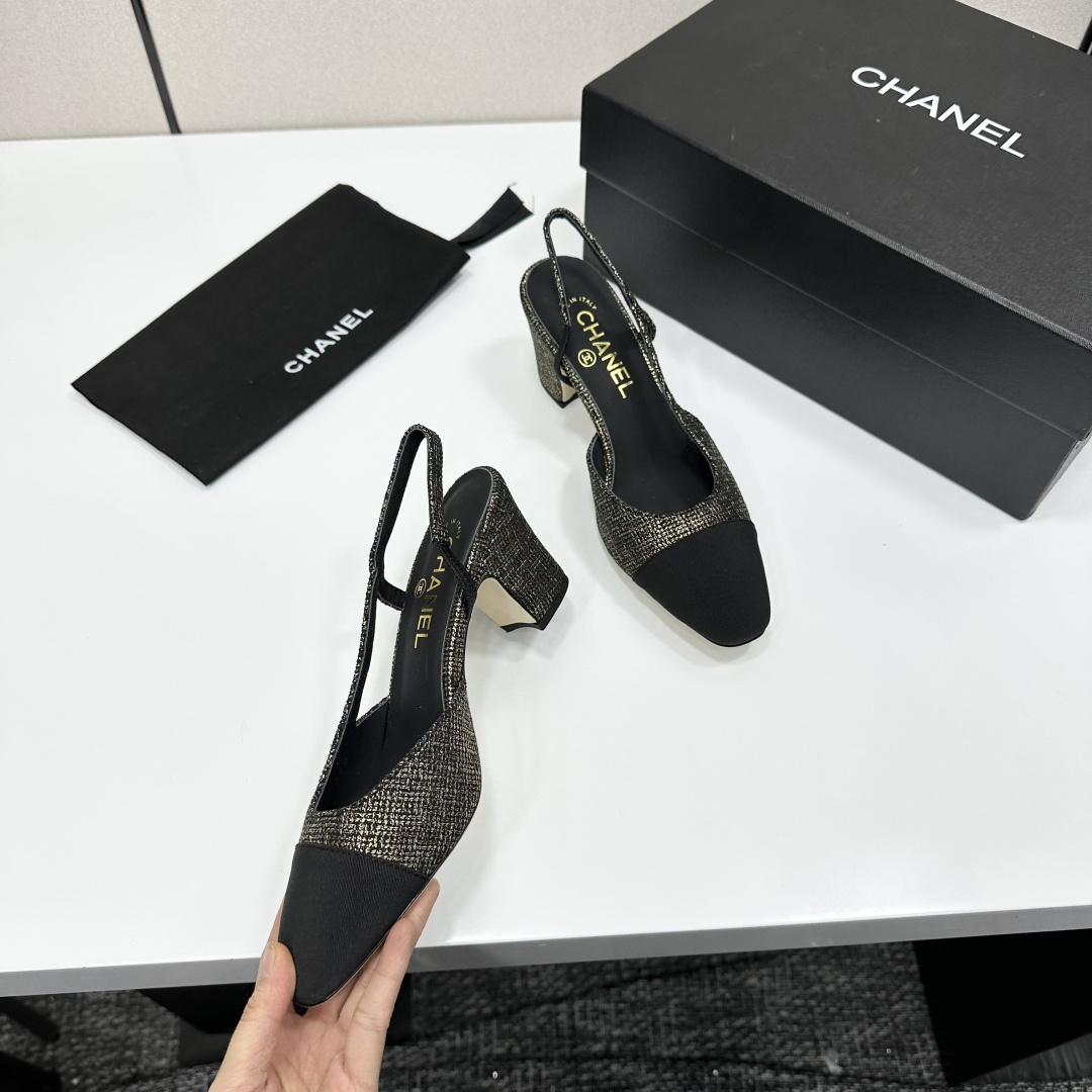 A pair of Chanel gold and black metallic tweed slingback pumps with black cap toes resting on a black designer box. - Hình 8