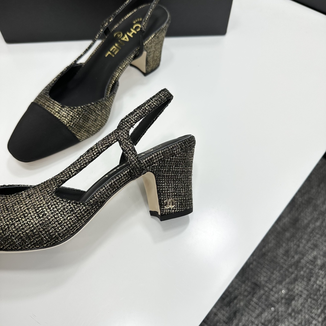 A pair of Chanel gold and black metallic tweed slingback pumps with black cap toes resting on a black designer box. - Hình 7