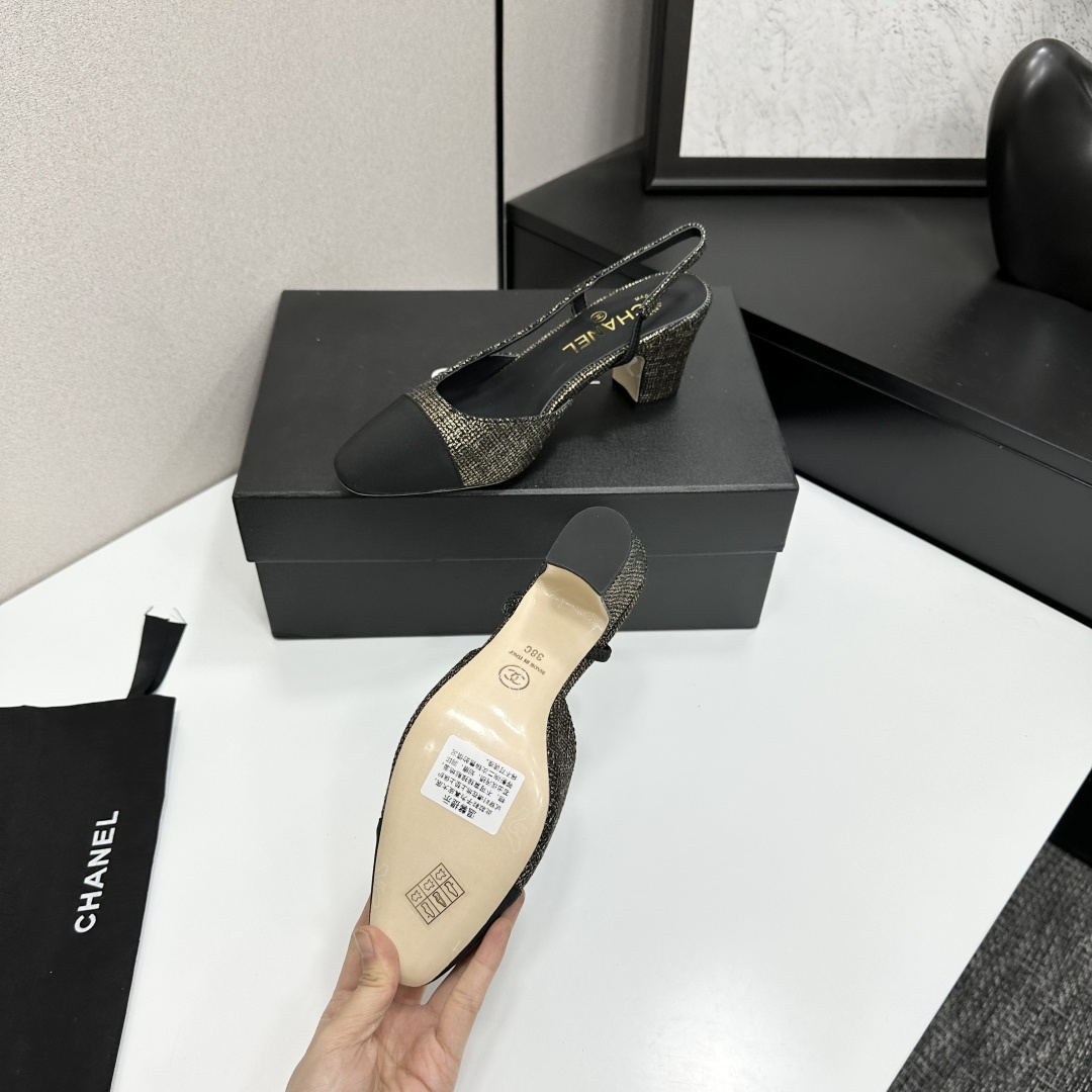 A pair of Chanel gold and black metallic tweed slingback pumps with black cap toes resting on a black designer box. - Hình 4