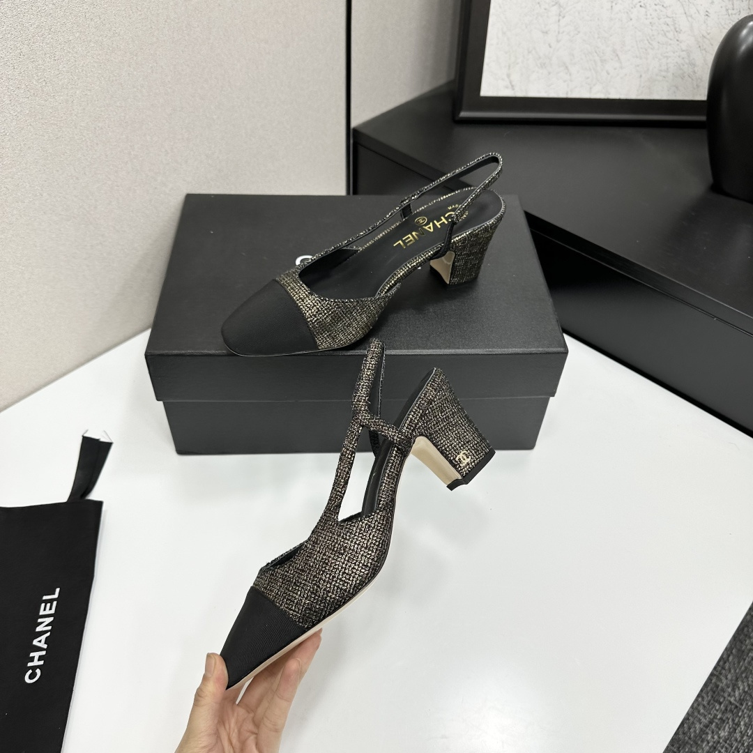A pair of Chanel gold and black metallic tweed slingback pumps with black cap toes resting on a black designer box. - Hình 3