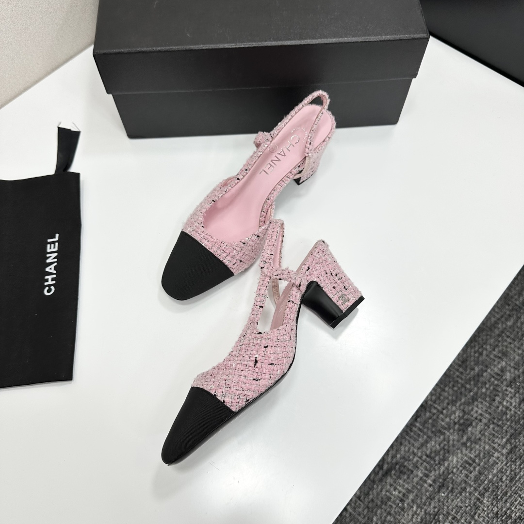 A pair of luxury Chanel pink tweed slingback pumps with a black toe cap and block heel displayed on a black designer box. - Hình 7