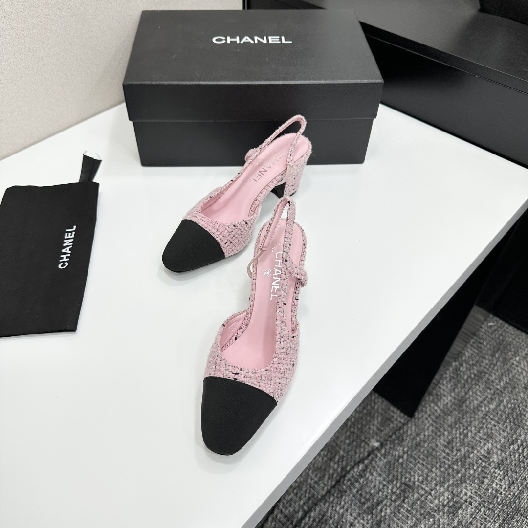 A pair of luxury Chanel pink tweed slingback pumps with a black toe cap and block heel displayed on a black designer box. - Hình 6