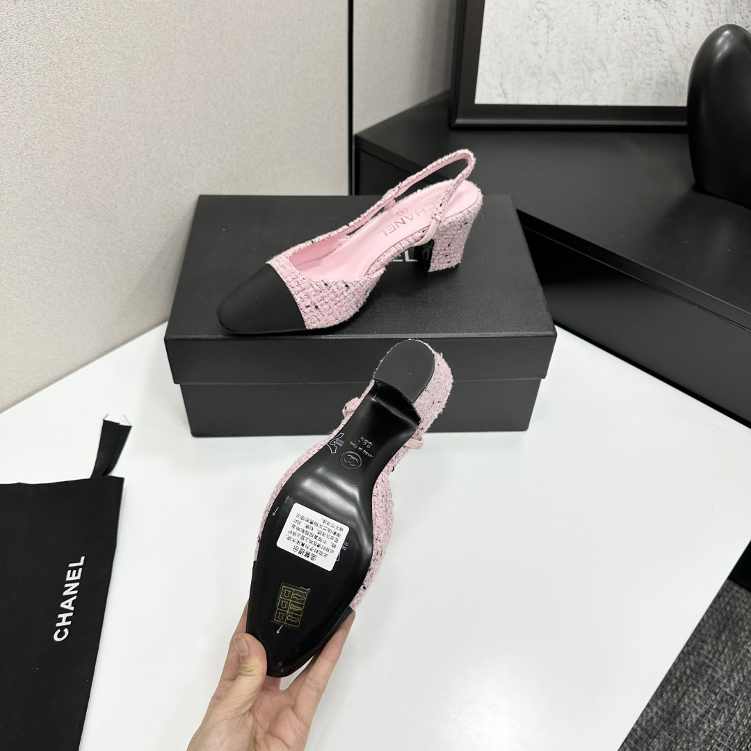A pair of luxury Chanel pink tweed slingback pumps with a black toe cap and block heel displayed on a black designer box. - Hình 5
