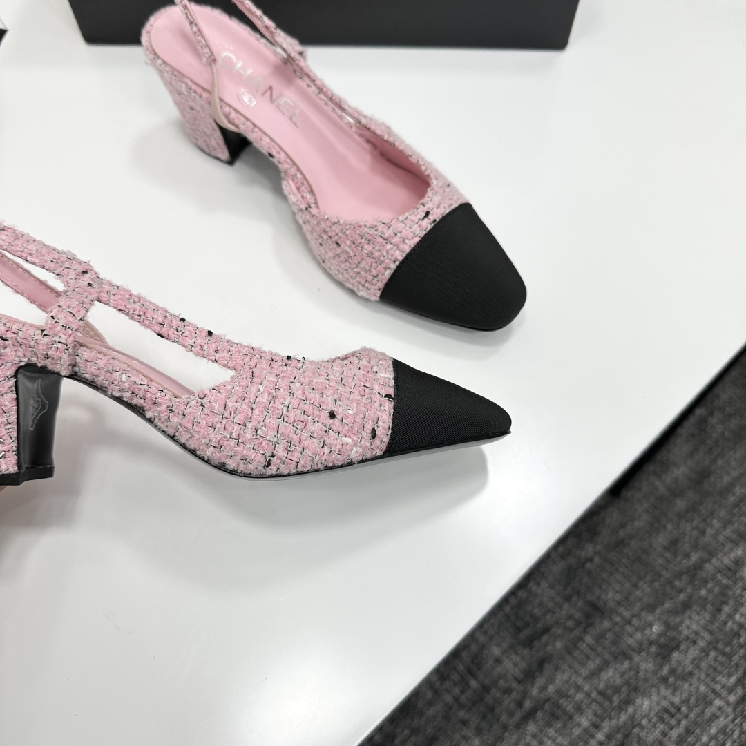 A pair of luxury Chanel pink tweed slingback pumps with a black toe cap and block heel displayed on a black designer box. - Hình 2