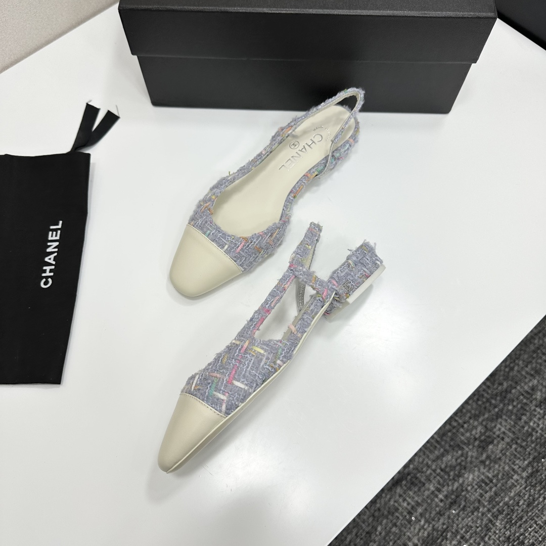 A pair of Chanel blue multi-color tweed slingback flats with cream leather cap toes resting on a black designer box - Hình 7