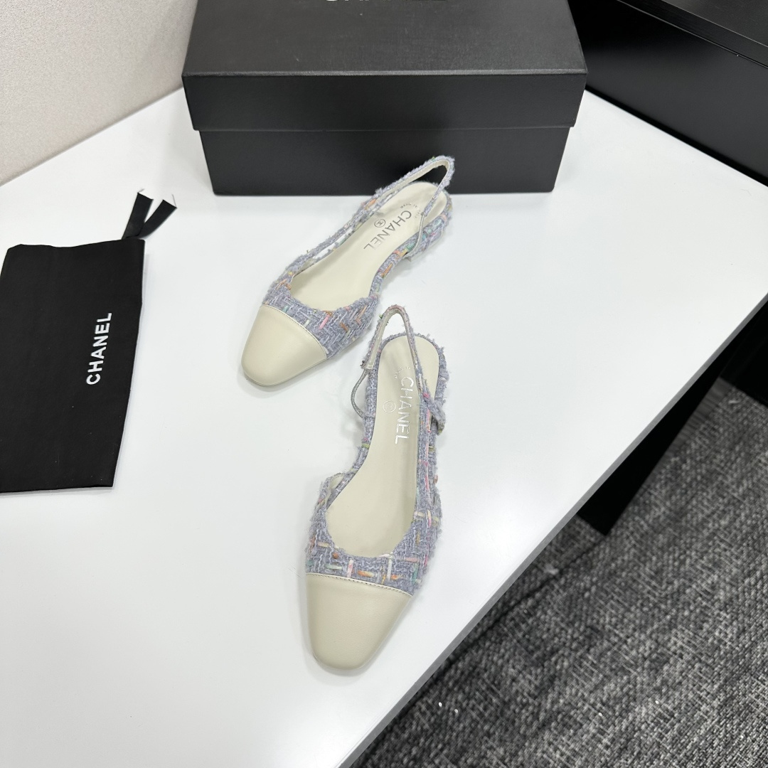 A pair of Chanel blue multi-color tweed slingback flats with cream leather cap toes resting on a black designer box - Hình 6