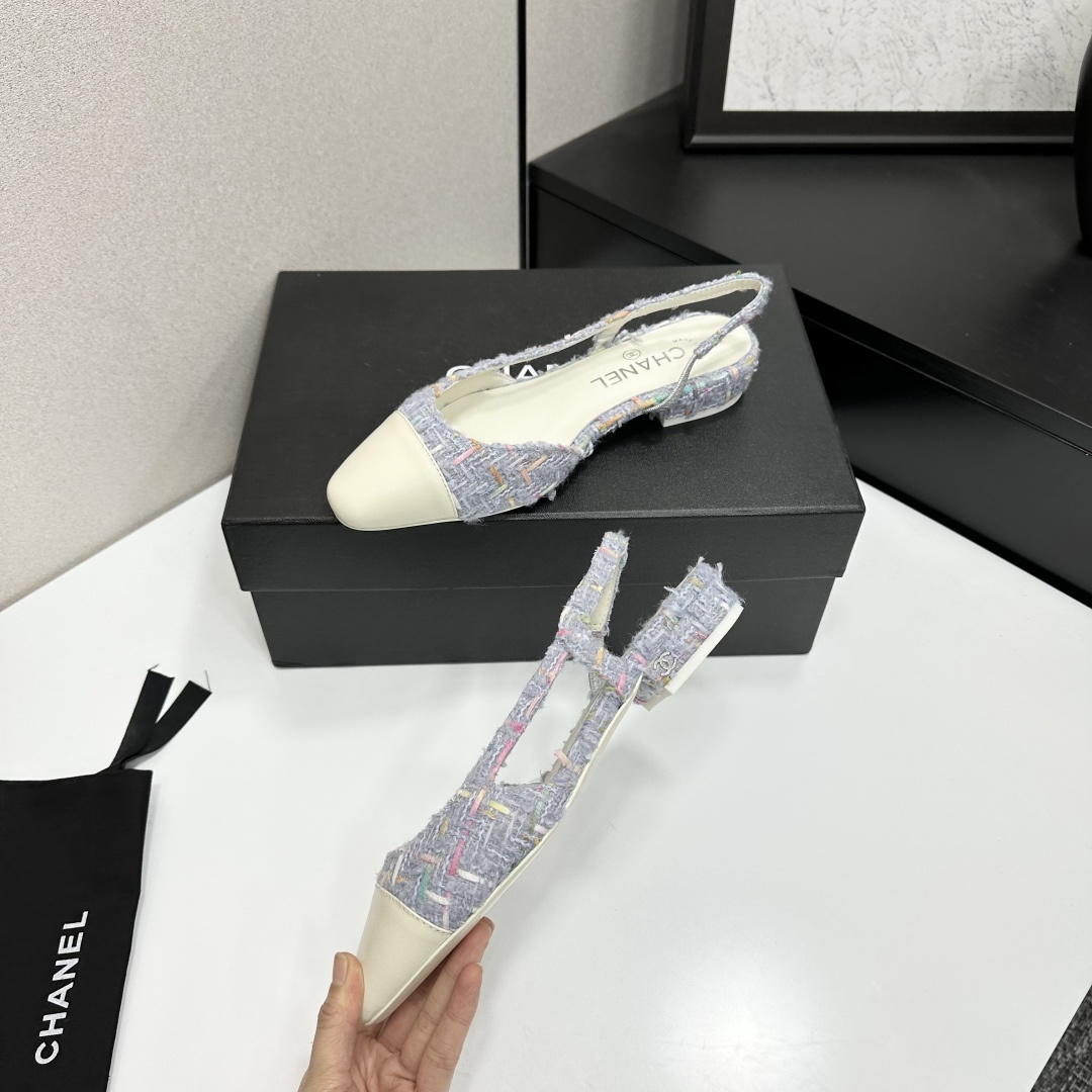 A pair of Chanel blue multi-color tweed slingback flats with cream leather cap toes resting on a black designer box - Hình 4