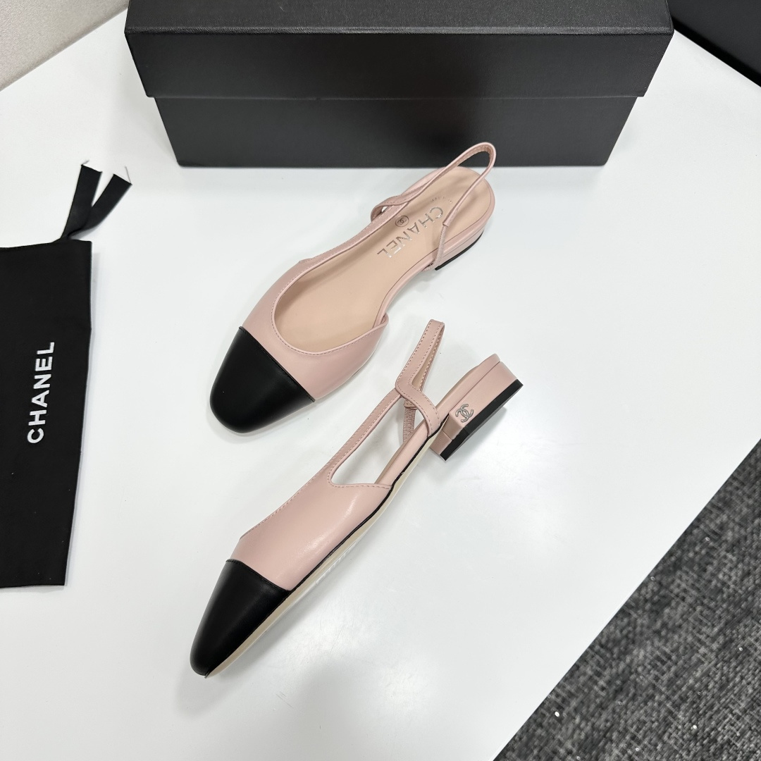 A pair of luxury Chanel pink and black two-tone slingback flats resting on a black designer shoe box. - Hình 7