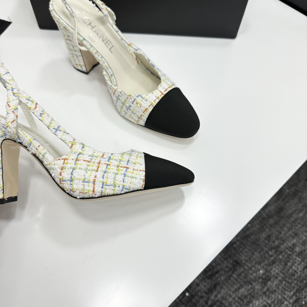 Pair of Chanel multi-color tweed slingback pumps with black cap toe and block heel displayed on a black box. - Hình 9