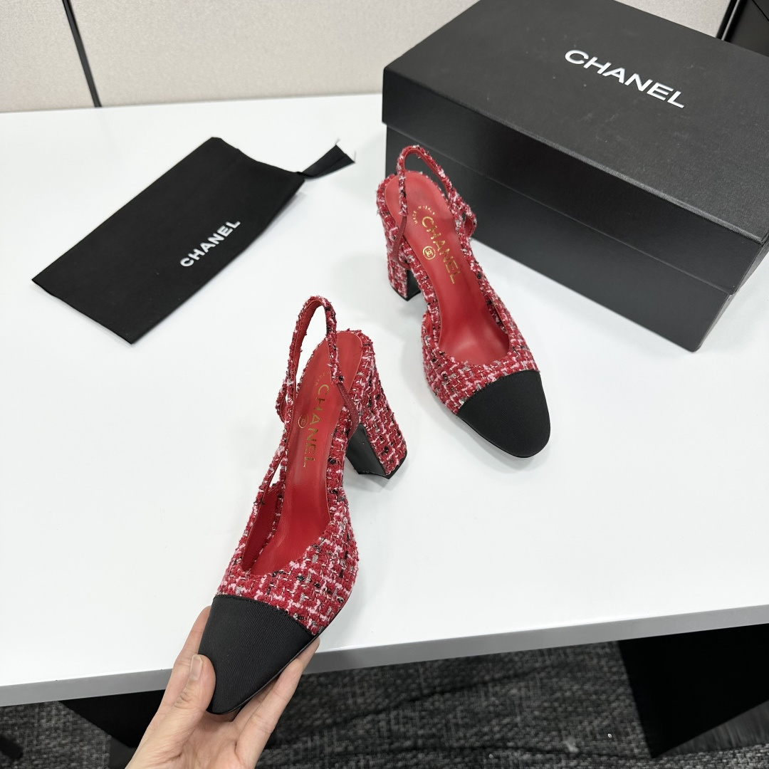 A pair of luxury Chanel red and white tweed slingback heels with black cap toes and chunky block heels displayed on a black branded box. - Hình 2